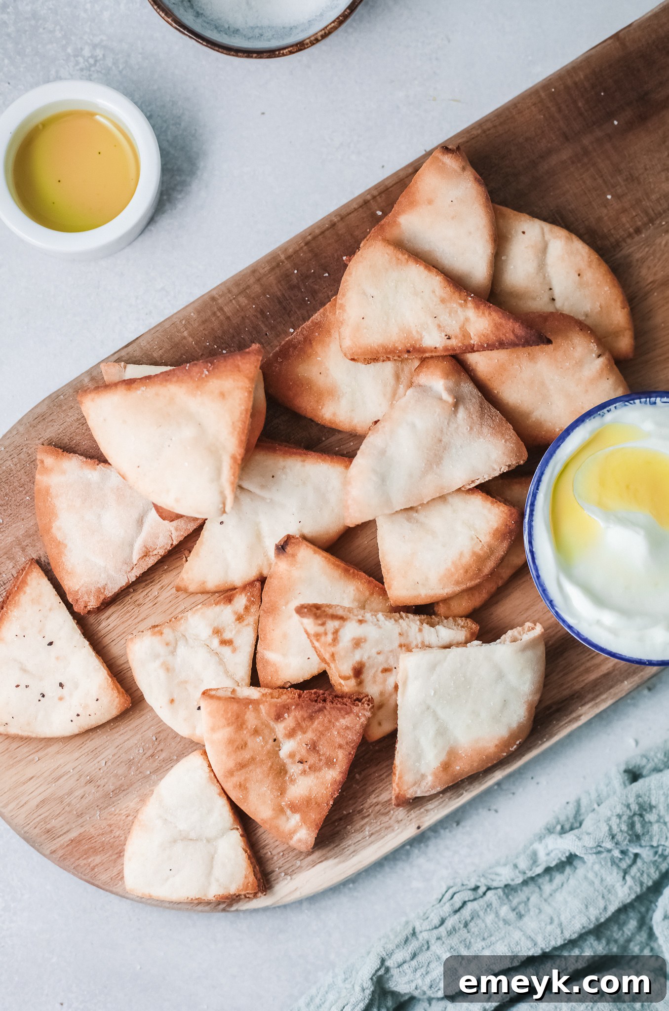 Air Fryer Pita Chips on a wooden board, ready to be served.