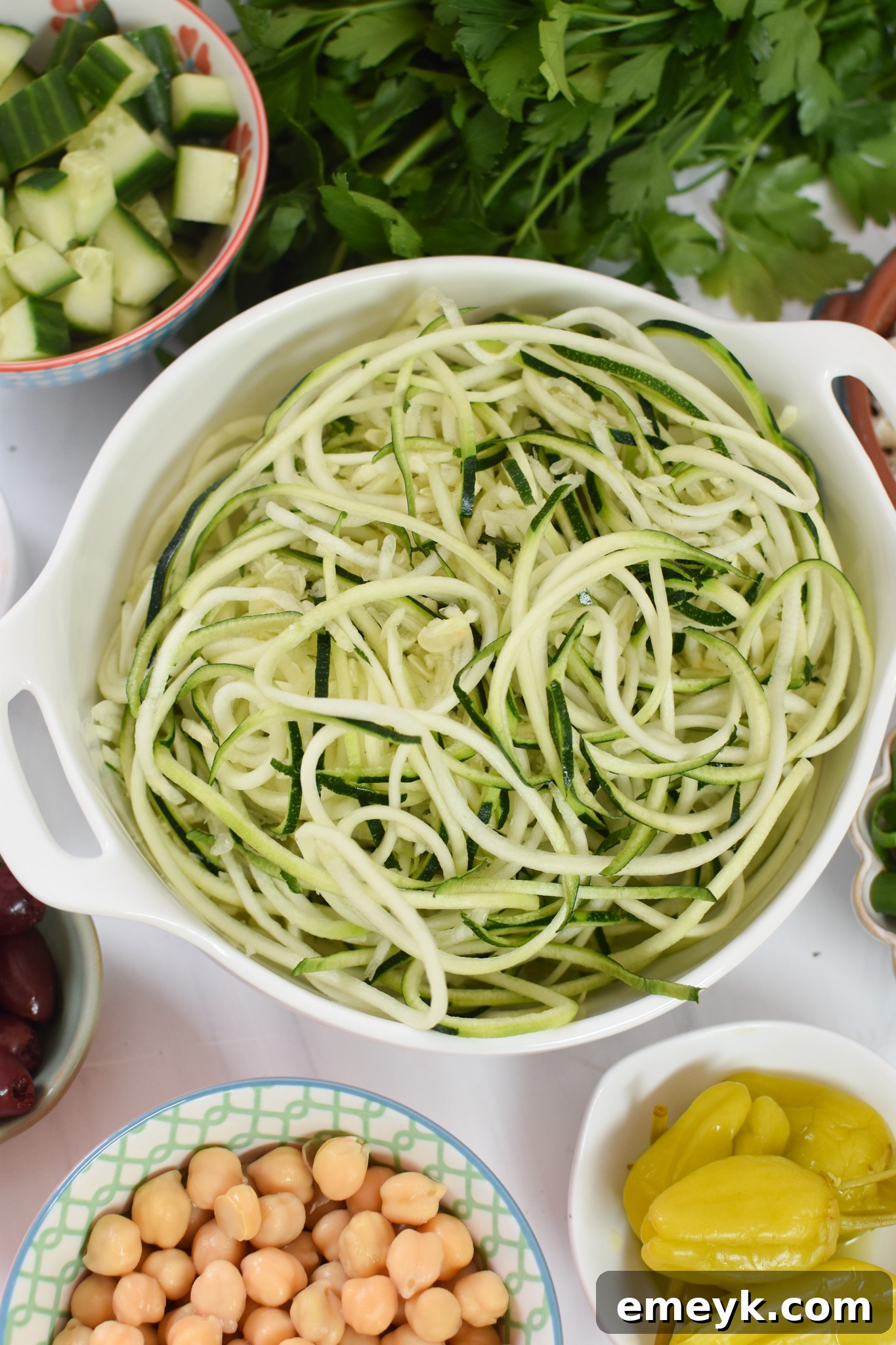 Zucchini and Pasta Mediterranean Medley 5 Freshly spiralized zucchini noodles laid out on paper towels to remove excess moisture, a key step for a crisp Mediterranean Zucchini Pasta Salad.