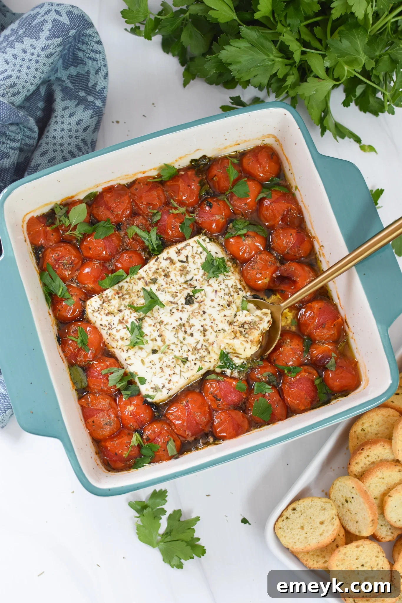 Effortless Baked Feta Delight 7 Easy Baked Feta Recipe served warm in a blue baking dish with bread.
