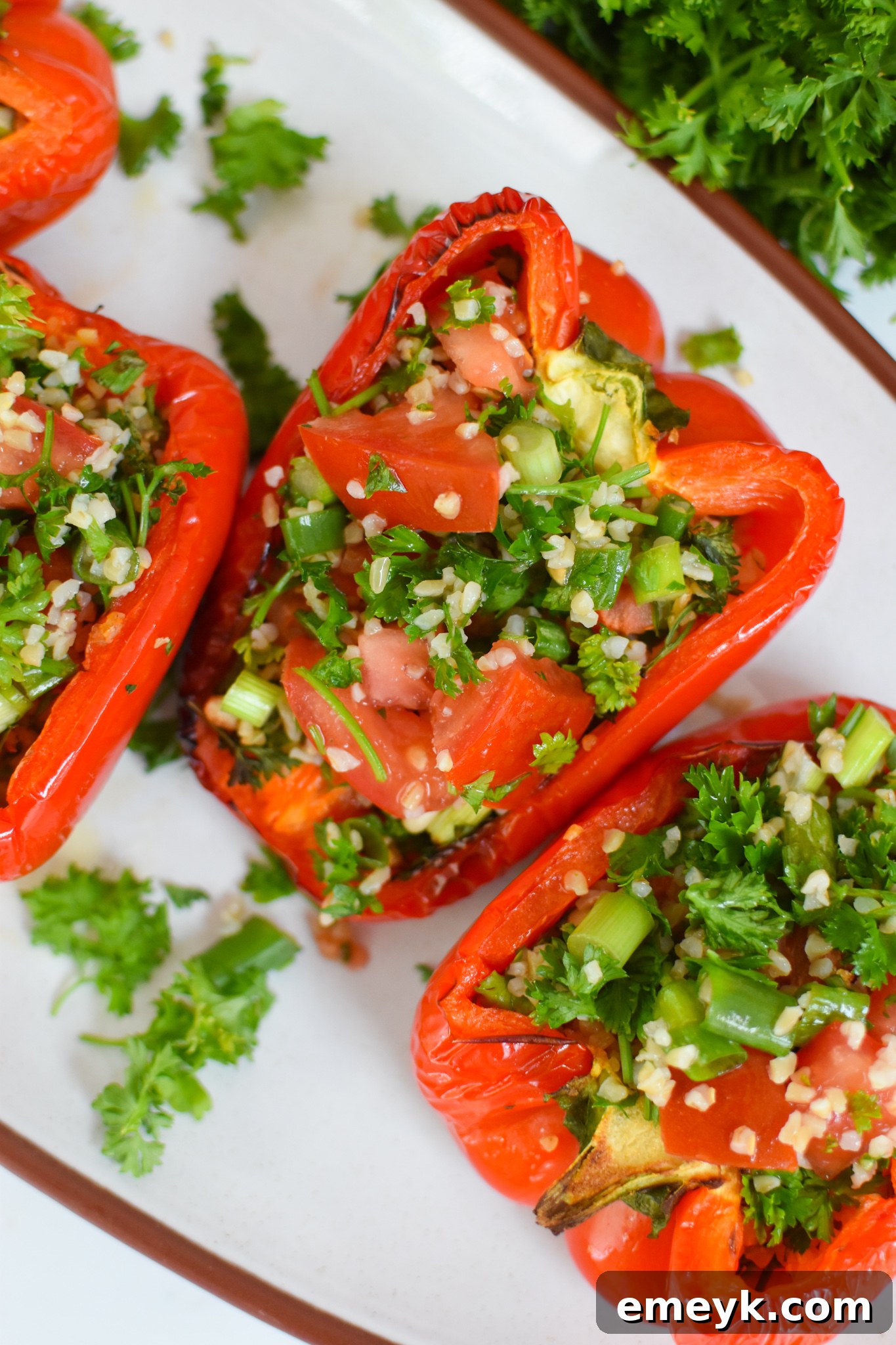 Vegan Tabbouleh Stuffed Peppers served on a white platter, showcasing vibrant colors.