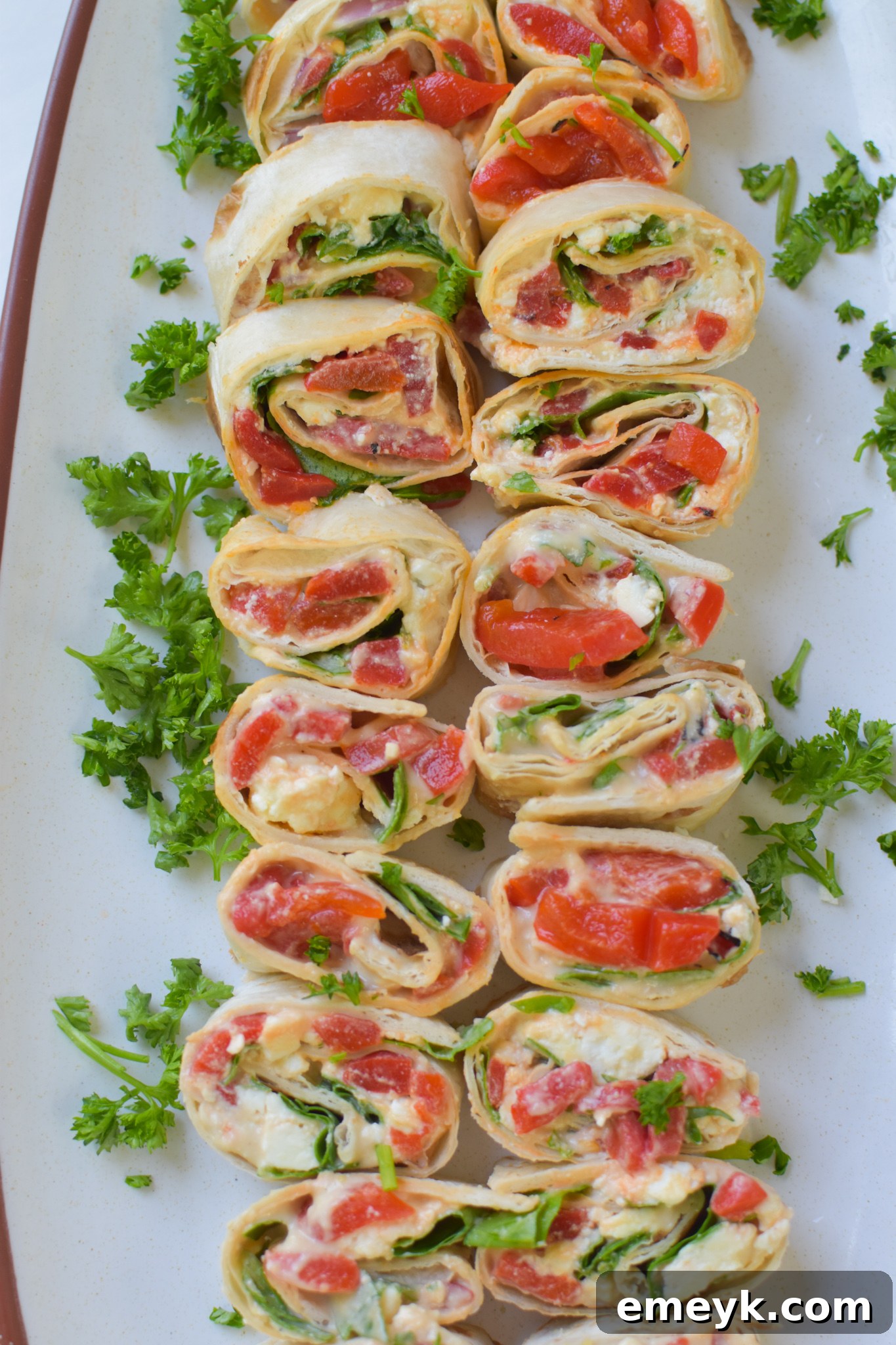 Fresh Mediterranean Pinwheels garnished with fresh parsley, ready to be served.