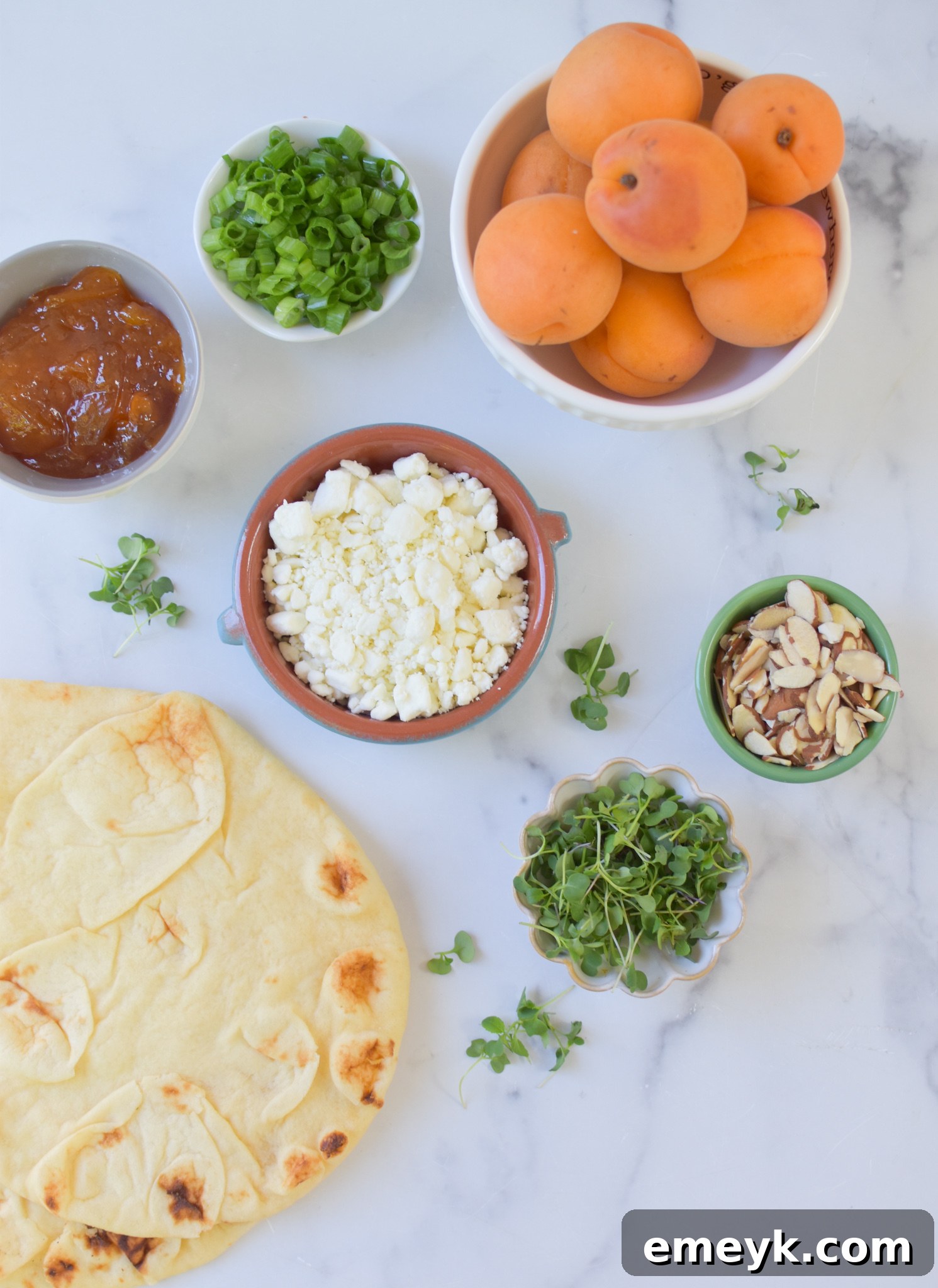 Golden Apricot & Chèvre Pizza 3 All the ingredients for Goat Cheese Apricot Pizza laid out on a kitchen counter.