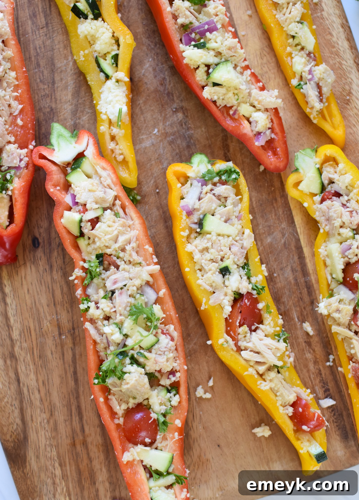 Stuffed sweet peppers arranged on a cutting board, ready to be served.