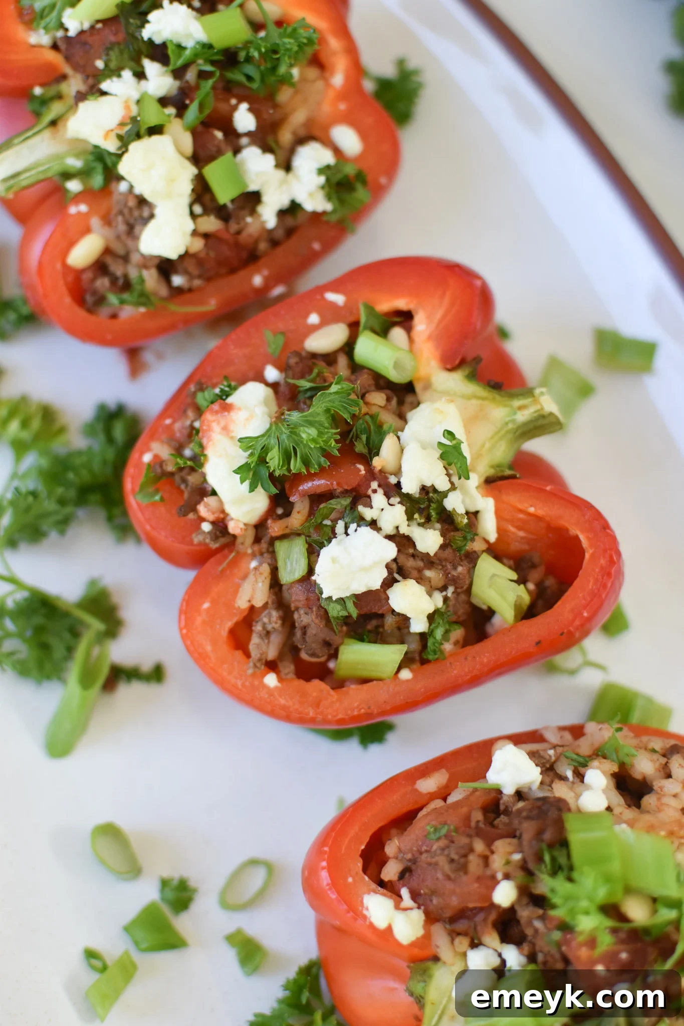 Mediterranean Ground Beef Stuffed Peppers on a white platter, ready to be served.