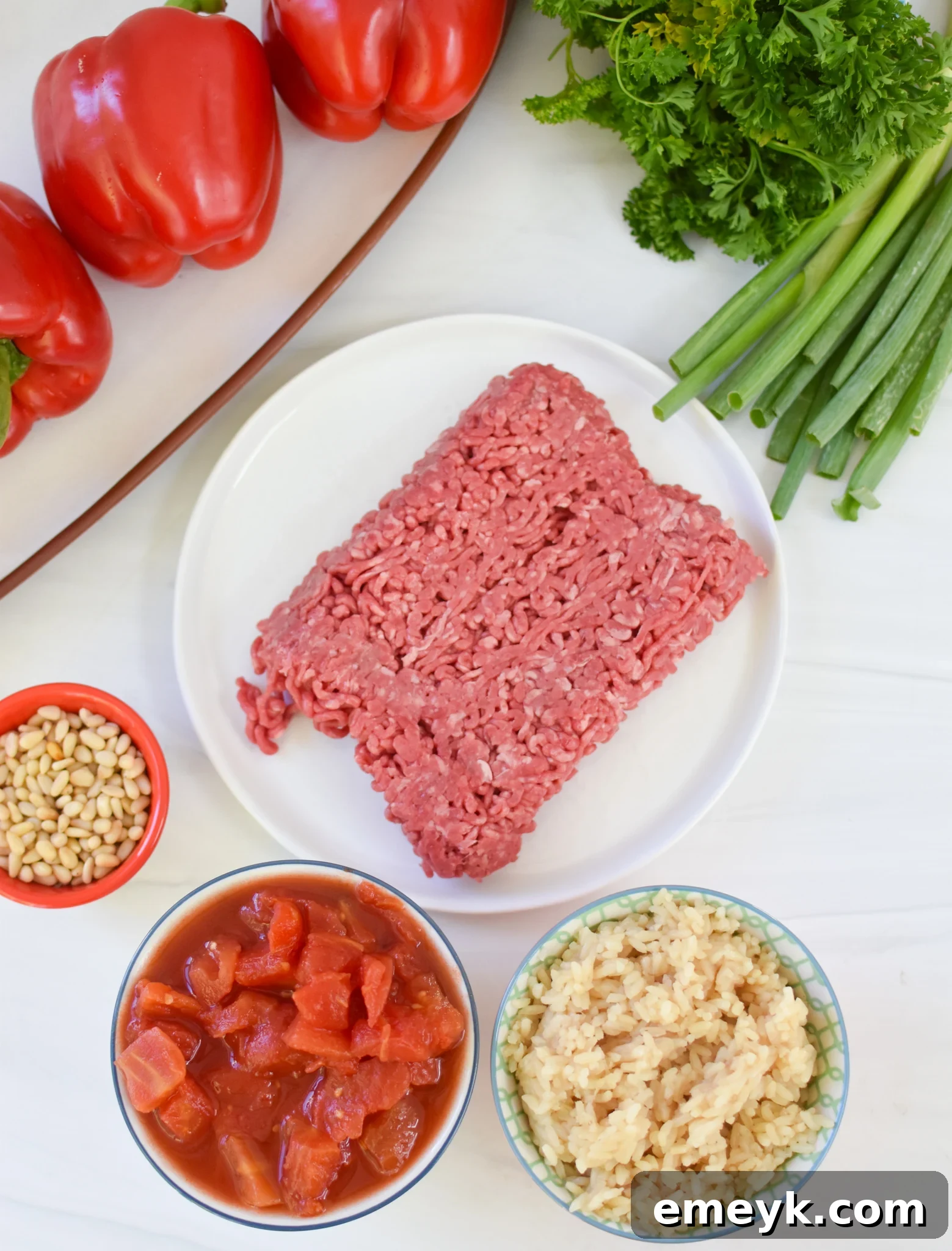 Hearty Mediterranean Beef Stuffed Peppers 5 Ingredients for Mediterranean Ground Beef Stuffed Peppers laid out on a table.