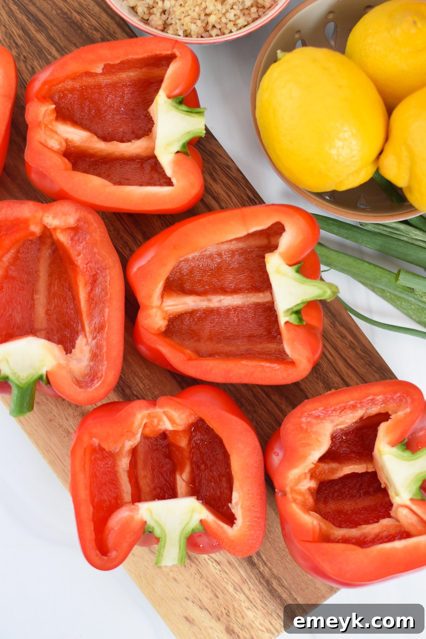 Hearty Mediterranean Beef Stuffed Peppers 7 Bell peppers sliced in half with seeds removed, arranged in a baking dish.