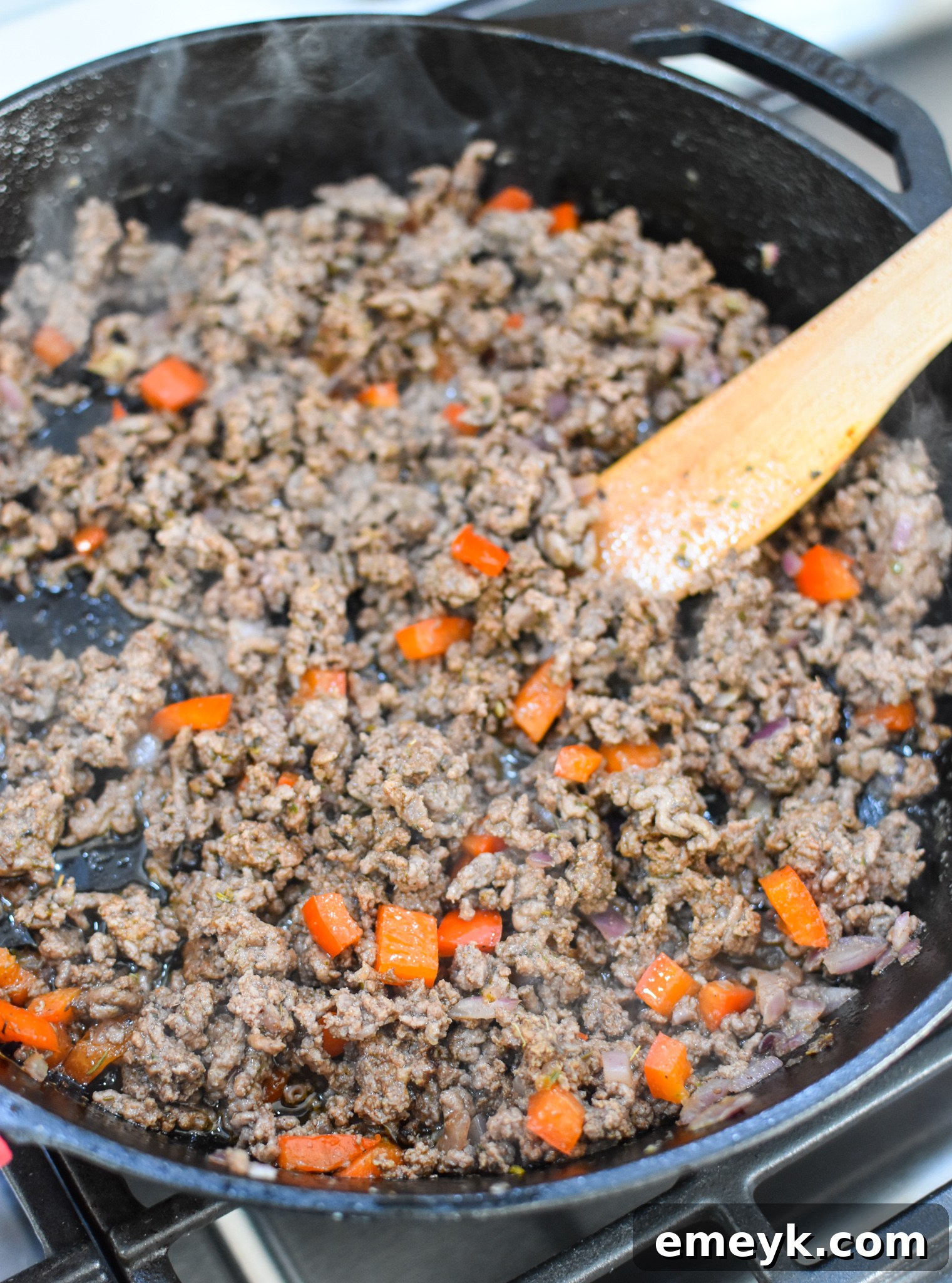 Hearty Mediterranean Beef Stuffed Peppers 8 Ground beef cooking in a skillet with spices, an essential step for Mediterranean Stuffed Peppers.