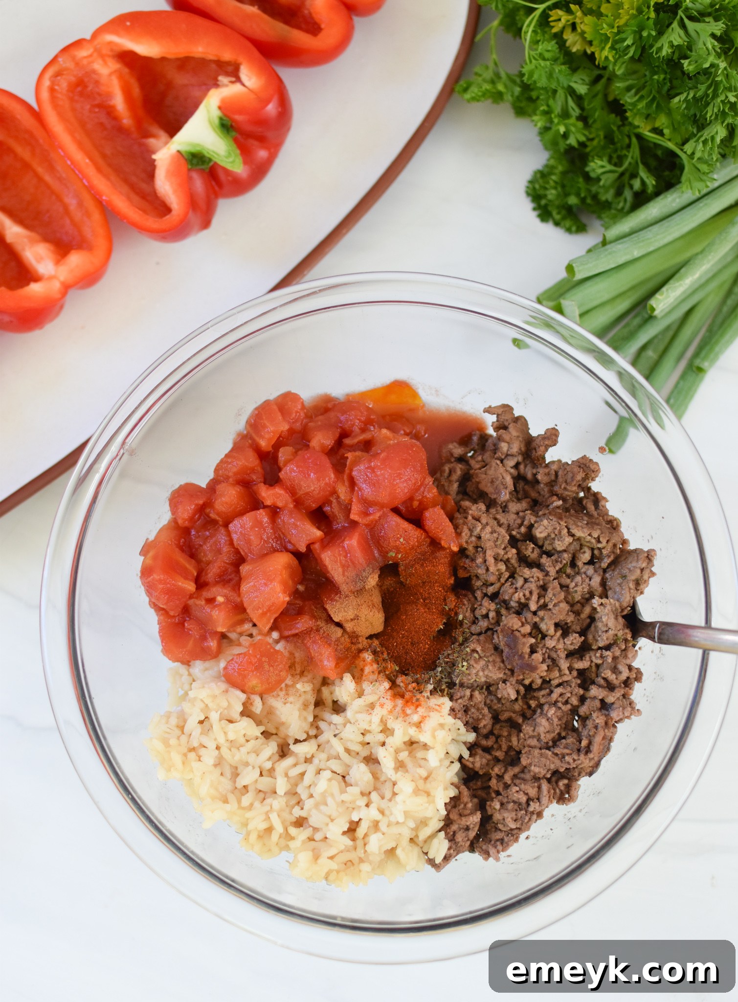 Hearty Mediterranean Beef Stuffed Peppers 9 The ground beef, rice, and diced tomato stuffing mixture in a bowl.