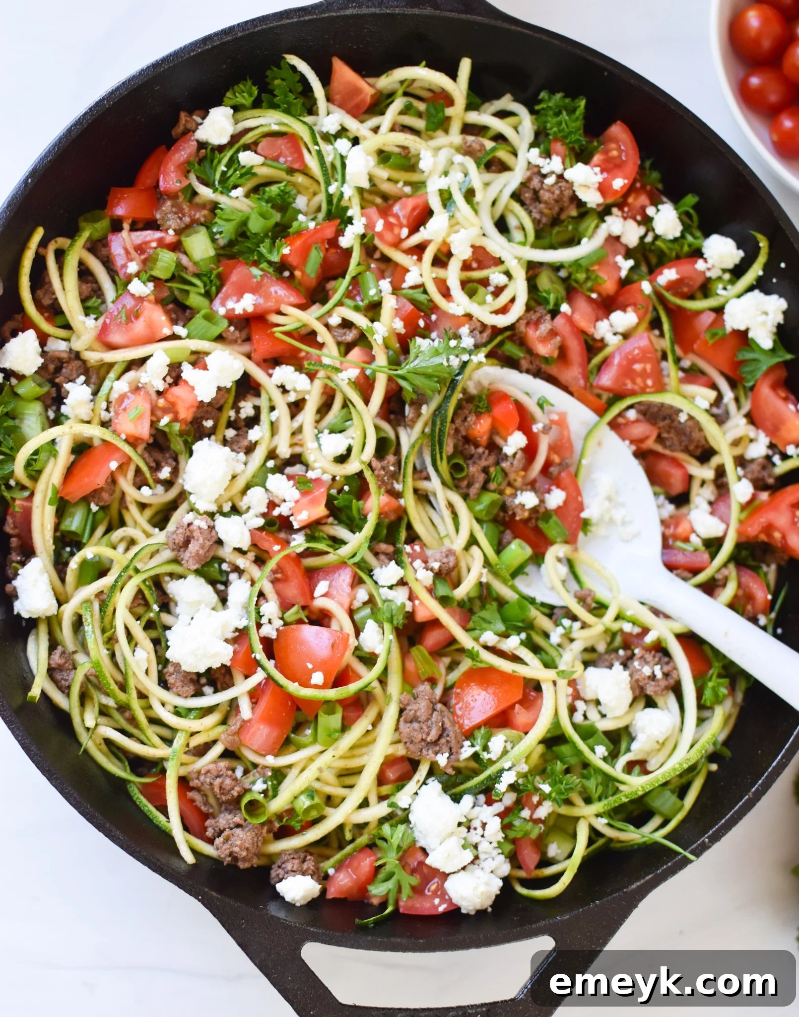 Delicious Mediterranean Ground Beef Zucchini Skillet with crumbled feta cheese and fresh herbs, ready to serve in a large skillet.