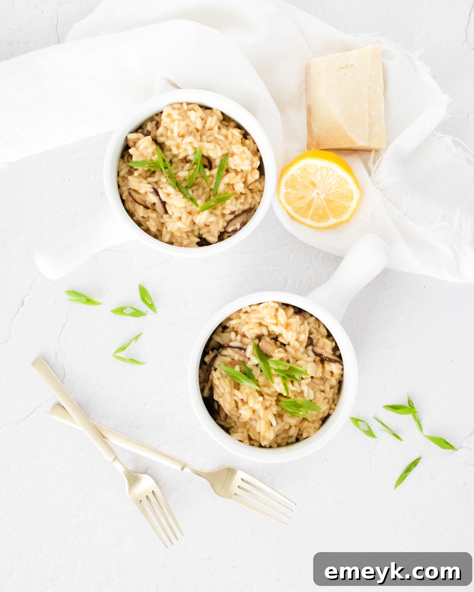 A fresh lemon half next to a bowl of Instant Pot Mushroom Risotto.