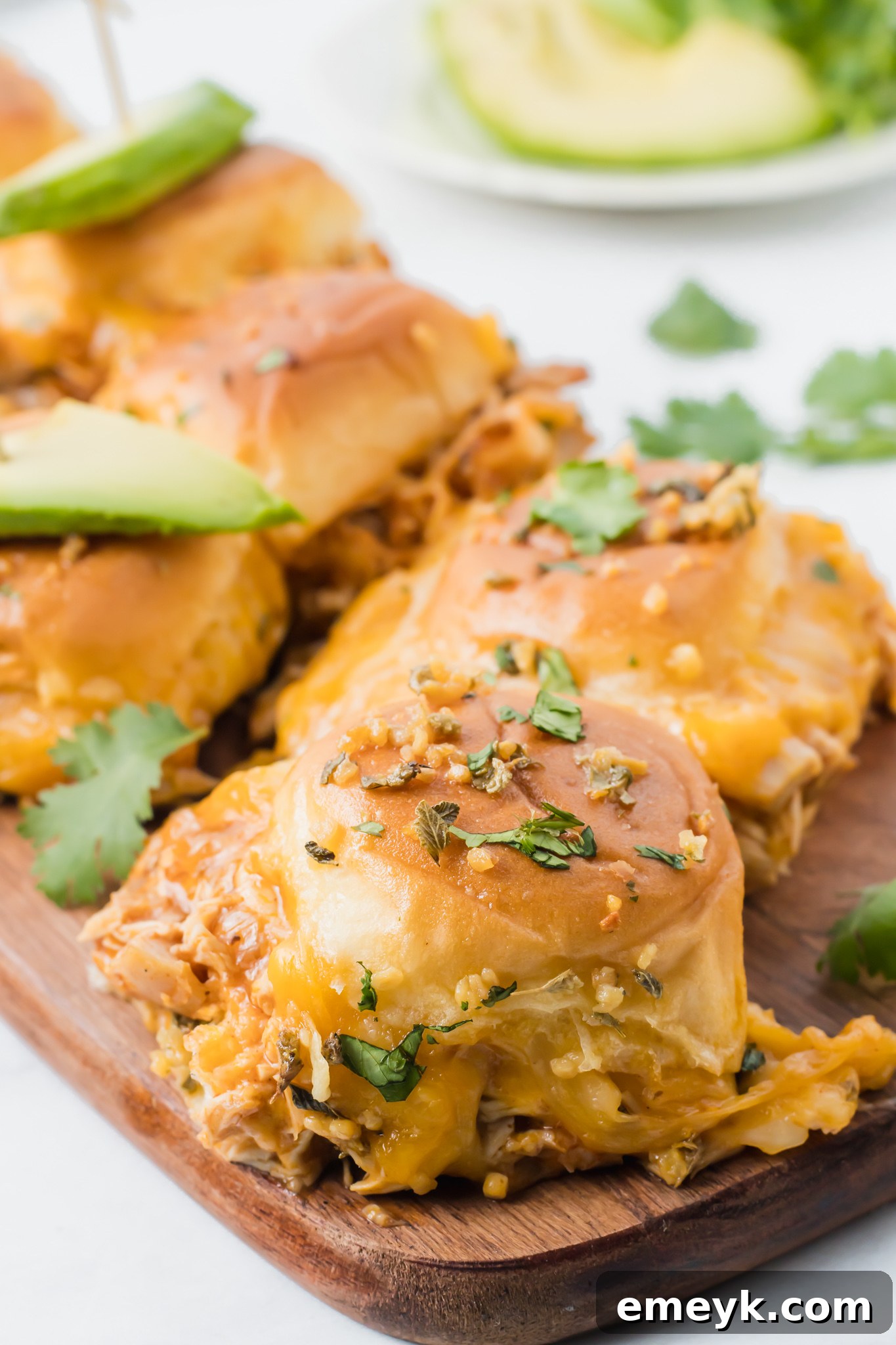 Chicken Enchilada Sliders with a savory herb butter topping brushed onto the buns before baking.