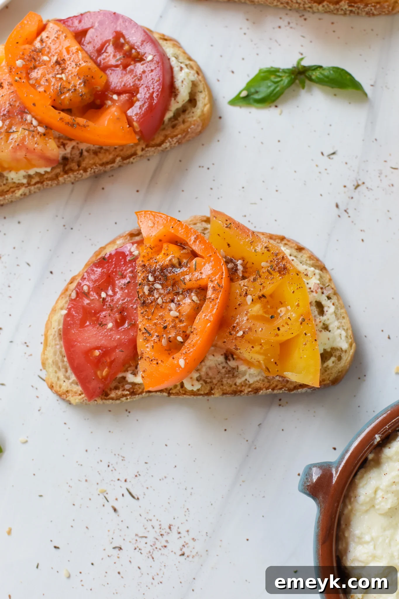 Tomato Toast with Whipped Feta with fresh basil.