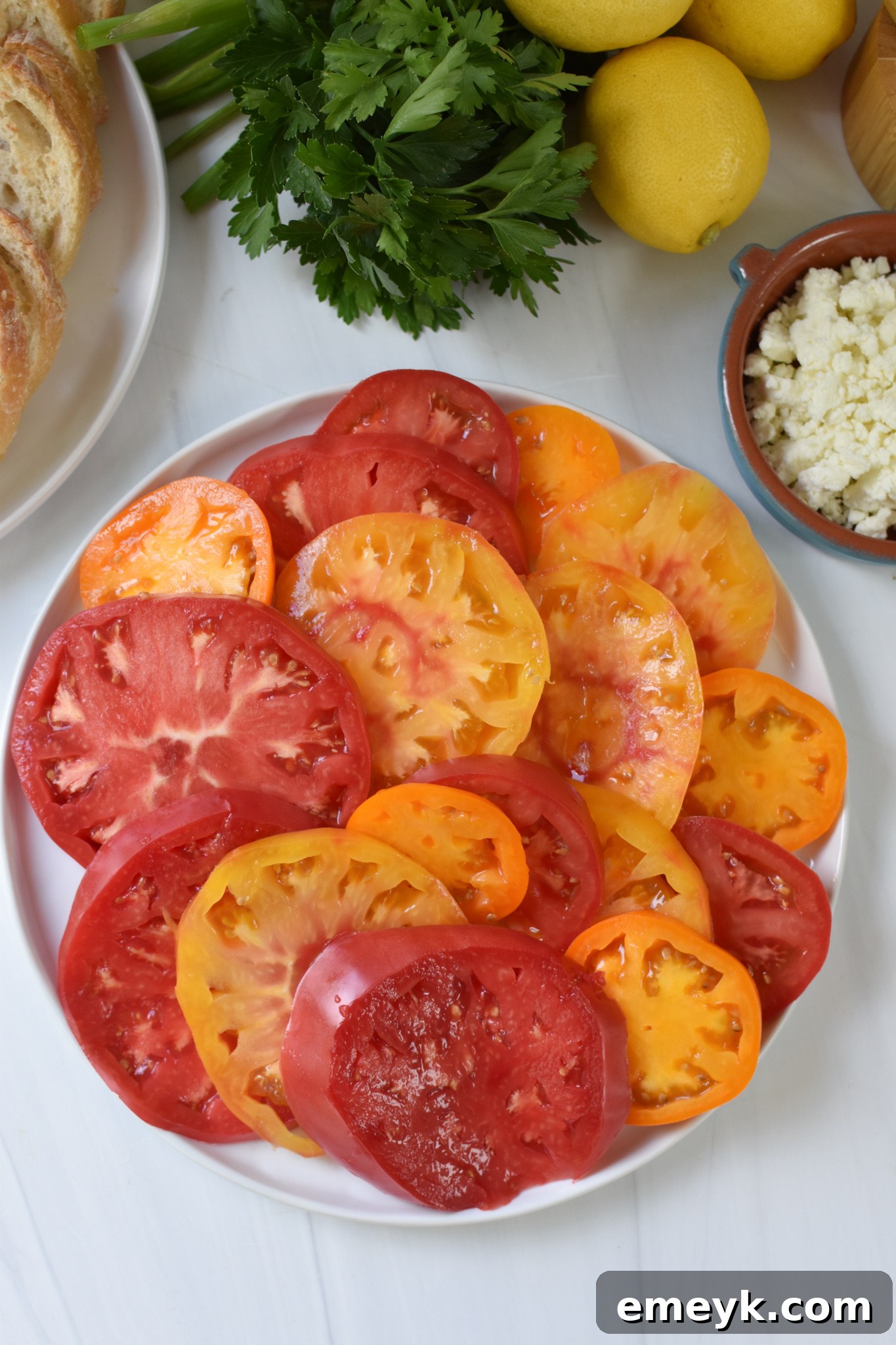 Tomato Toast with Whipped Feta heirloom tomatoes on a white plate.