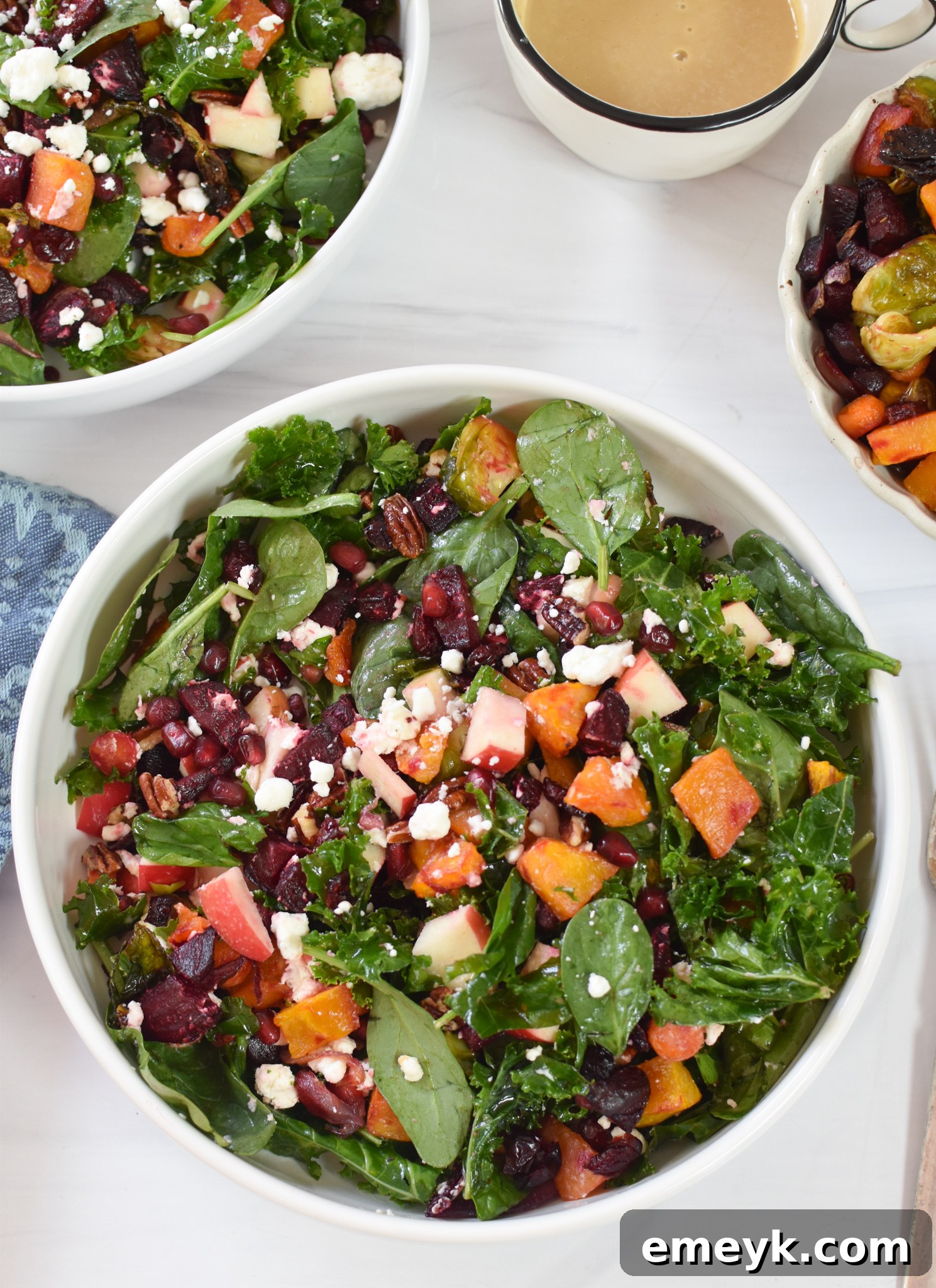 A large serving of Fall Harvest Salad in a white bowl, ready to be enjoyed.