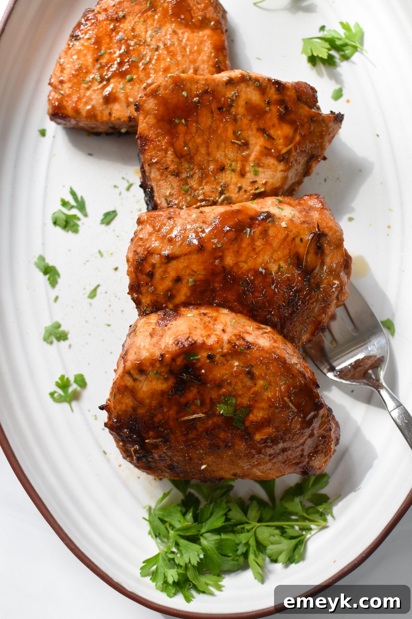 Air Fryer Boneless Pork Chops on a white plate after cooking.