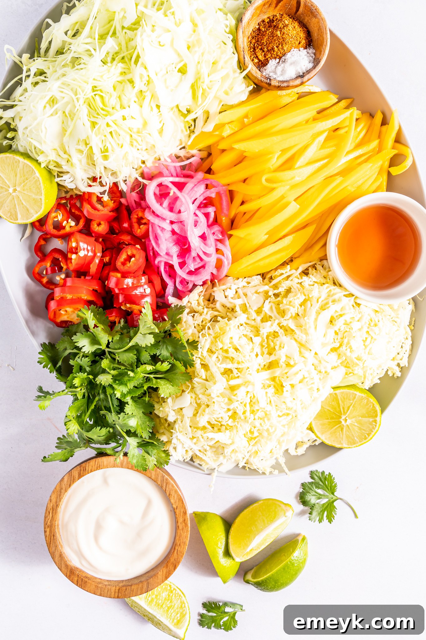 A vibrant selection of fresh ingredients for Easy Caribbean Coleslaw, artfully arranged on a plate.