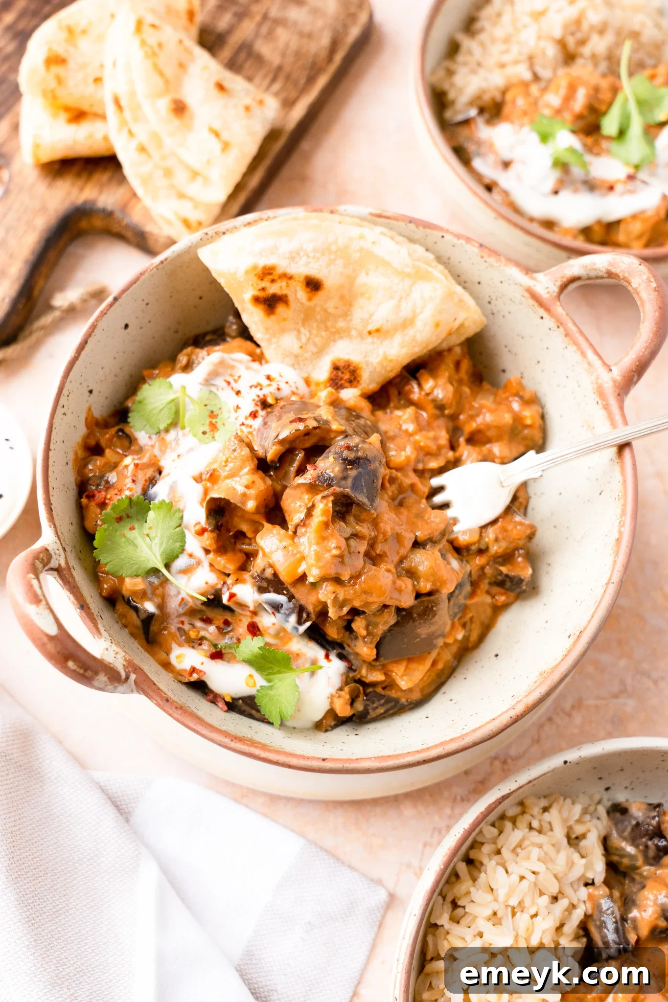Weeknight Eggplant Wonder 2 A vibrant bowl of Easy Eggplant Curry, rich with spices and creamy coconut milk, garnished with fresh cilantro and ready to be enjoyed.