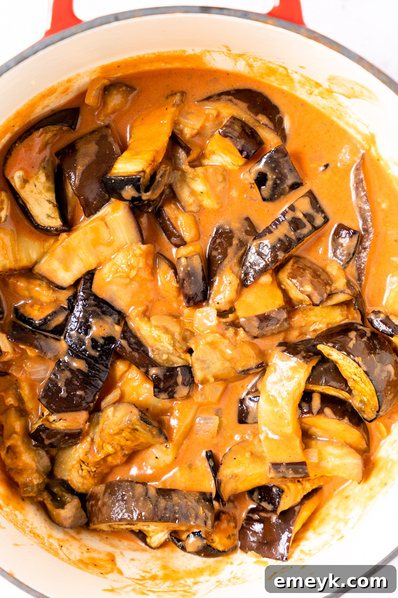 Weeknight Eggplant Wonder 7 Easy Eggplant Curry simmering in a pot with roasted eggplant, a rich tomato, and coconut milk sauce.