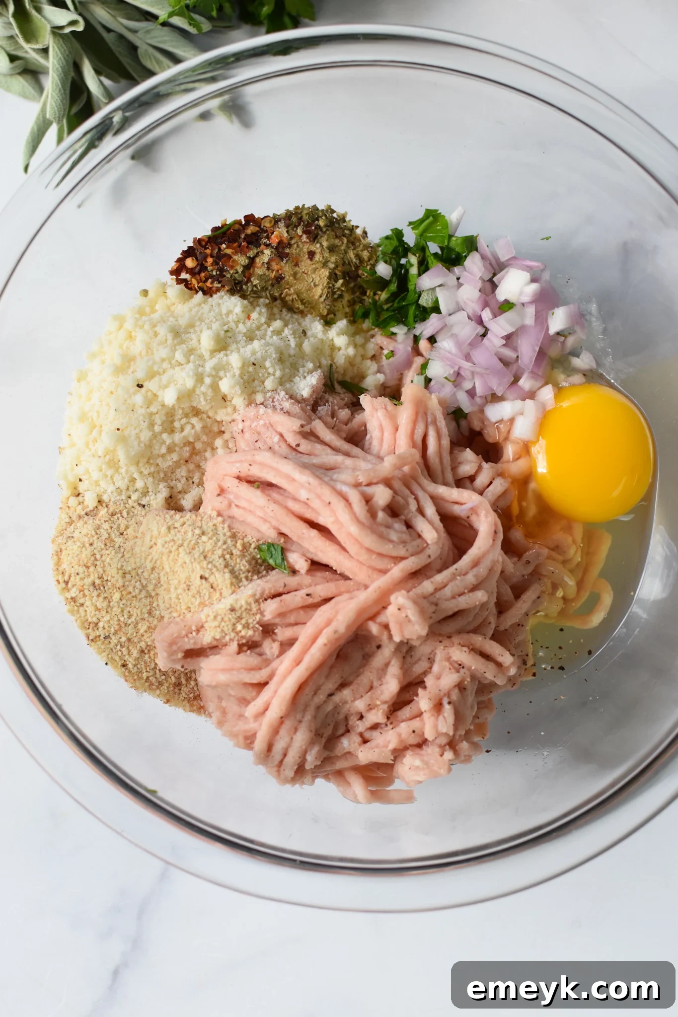 Baked Chicken Meatballs ingredients in a bowl. All elements are perfectly mixed, creating a uniform and fragrant blend before shaping.