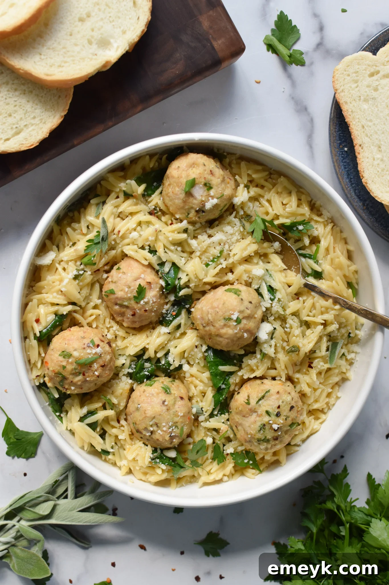 Baked Chicken Meatballs in a bowl with a fork. A wholesome and delicious meal ready to be savored and enjoyed.
