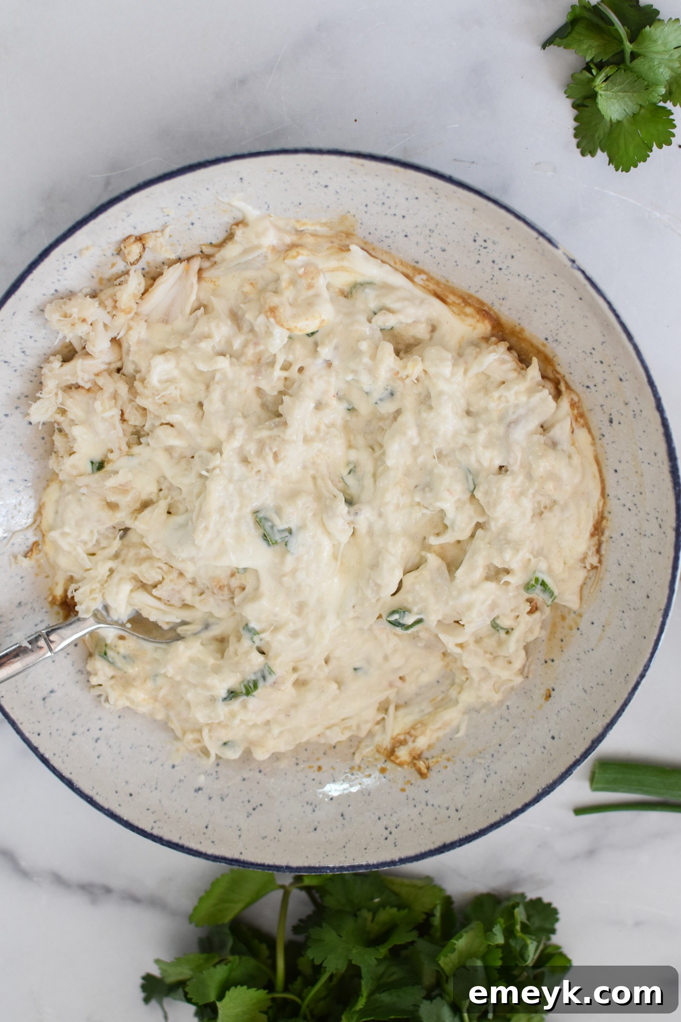 A bowl filled with the creamy crab rangoon mixture, ready for filling.