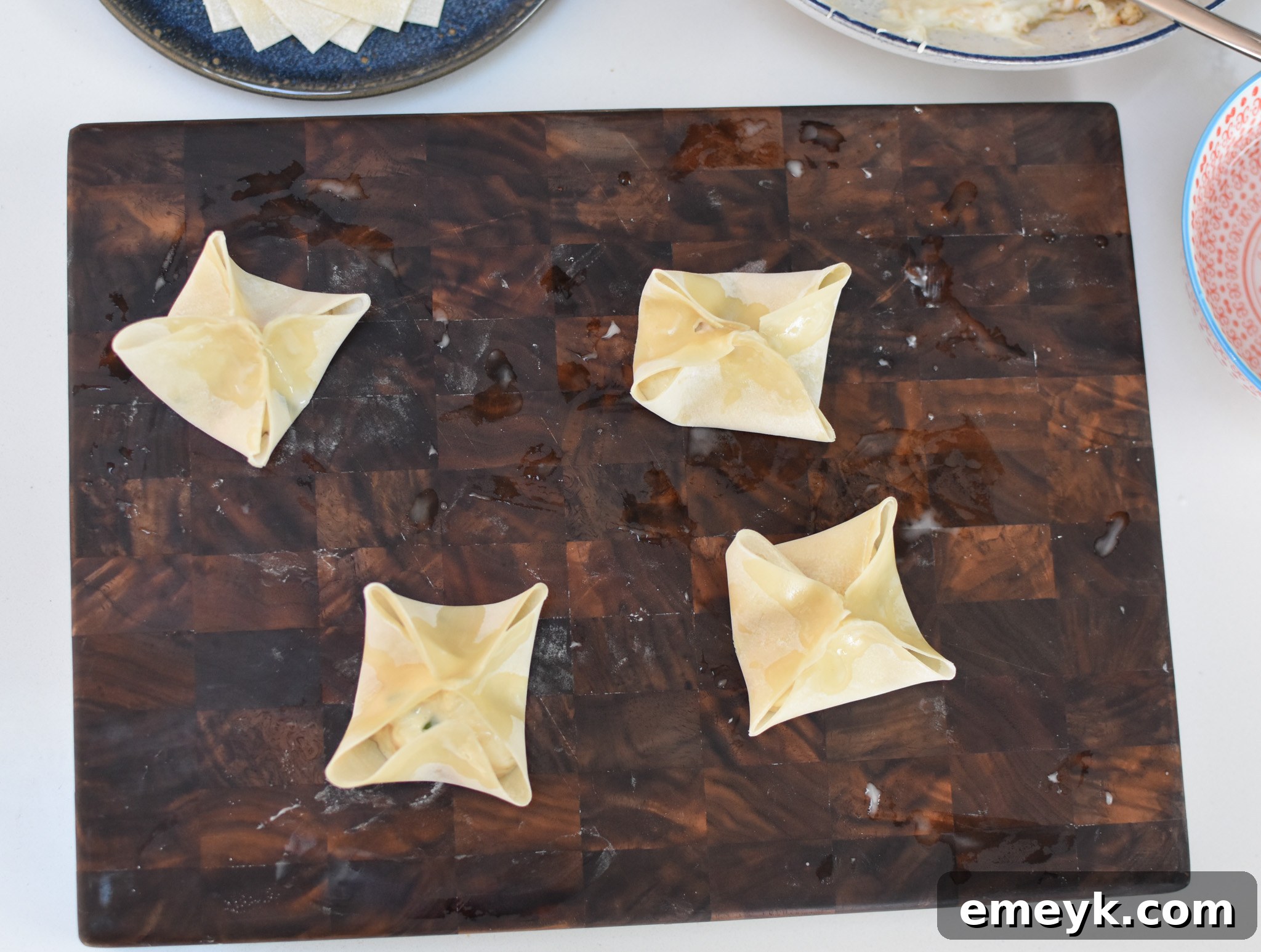 Several neatly folded Air Fryer Crab Rangoon, waiting to be cooked.