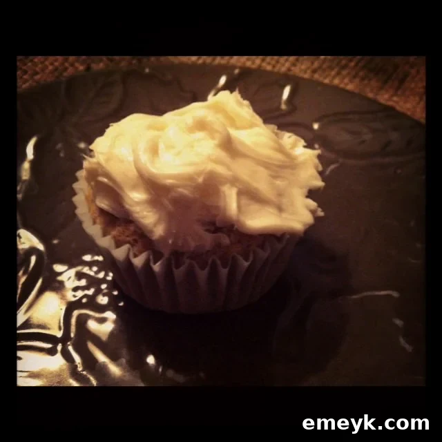 A perfectly frosted carrot cupcake, ready to be enjoyed