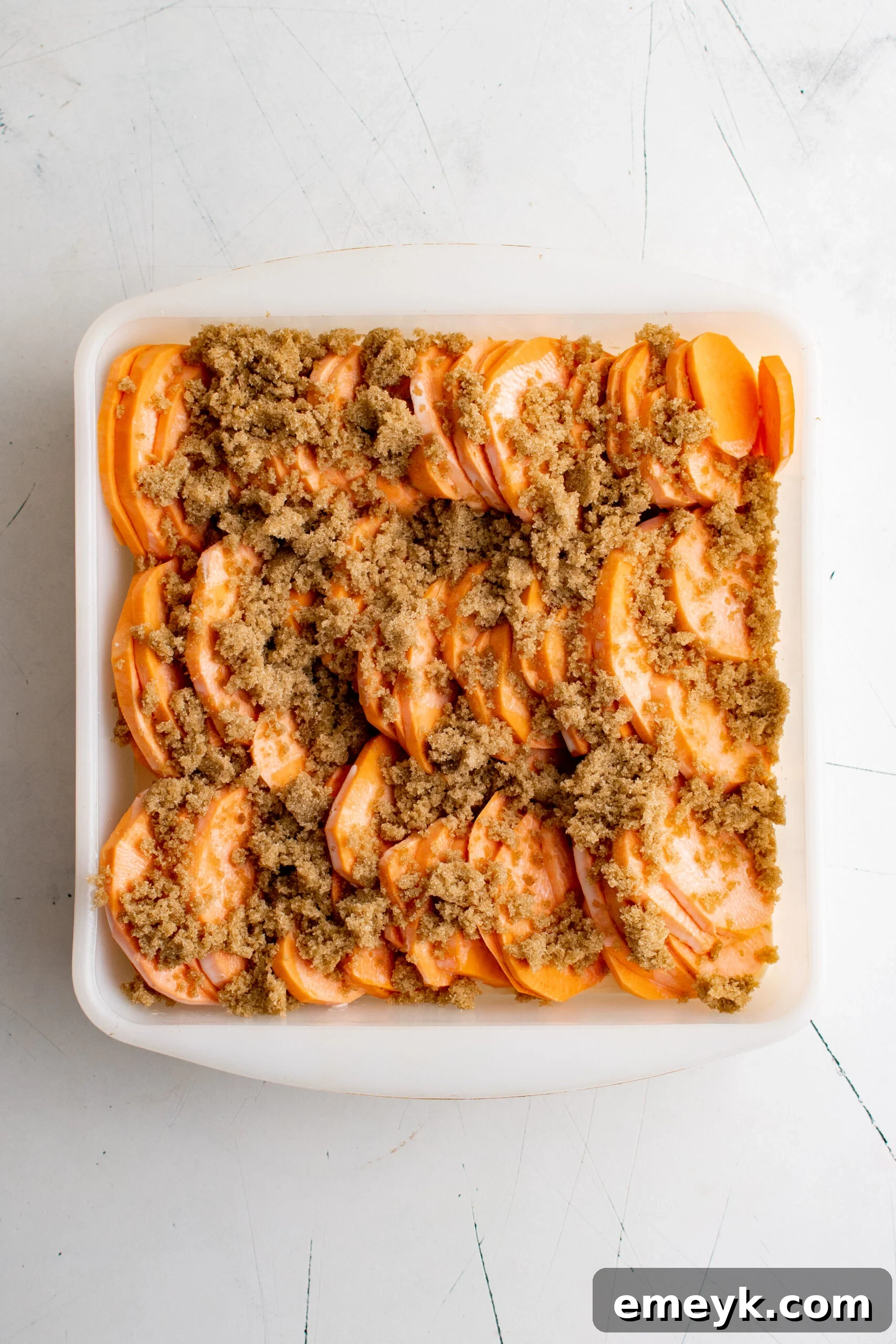 Easy Scalloped Sweet Potatoes with brown sugar and spices added.