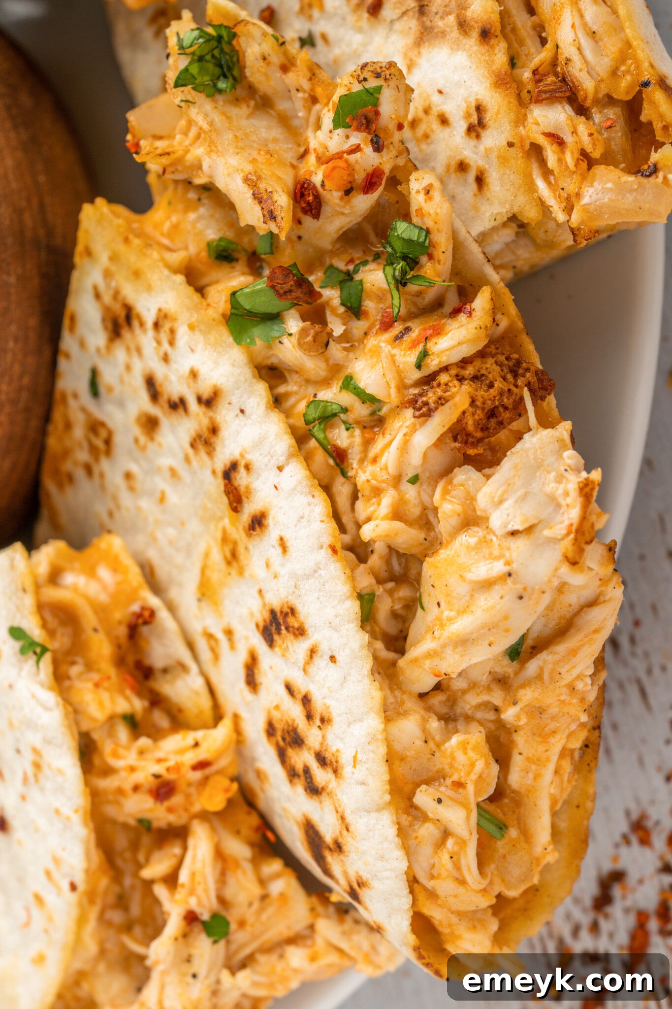 Quick Buffalo Chicken Quesadilla 4 Easy Buffalo Chicken Quesadilla garnished with fresh cilantro, ready to serve