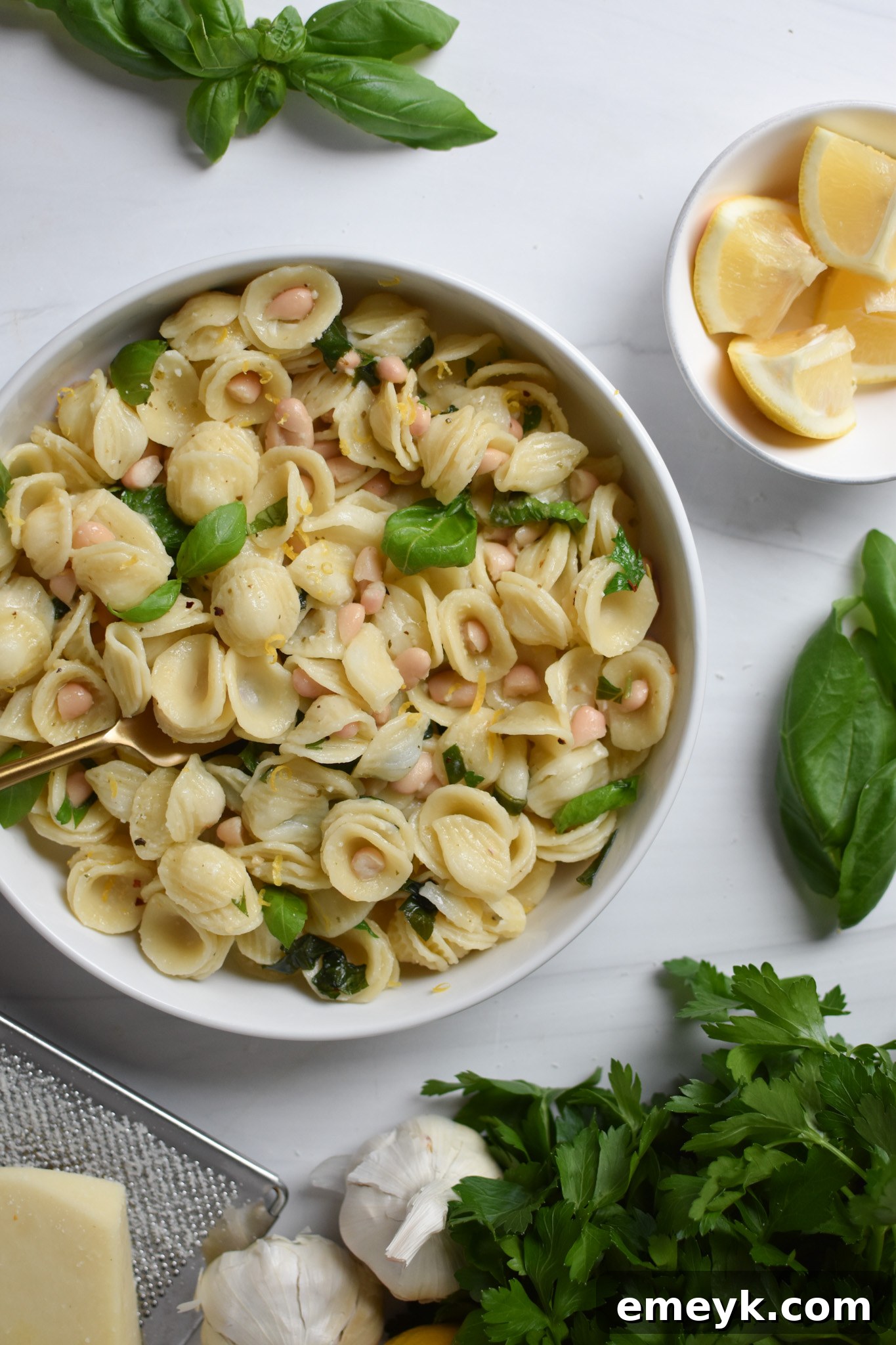 Zesty Lemon Basil White Bean Pasta 6 A close-up of Lemon Basil White Bean Pasta in a bowl, showing the creamy white beans and vibrant basil leaves mixed throughout the pasta.