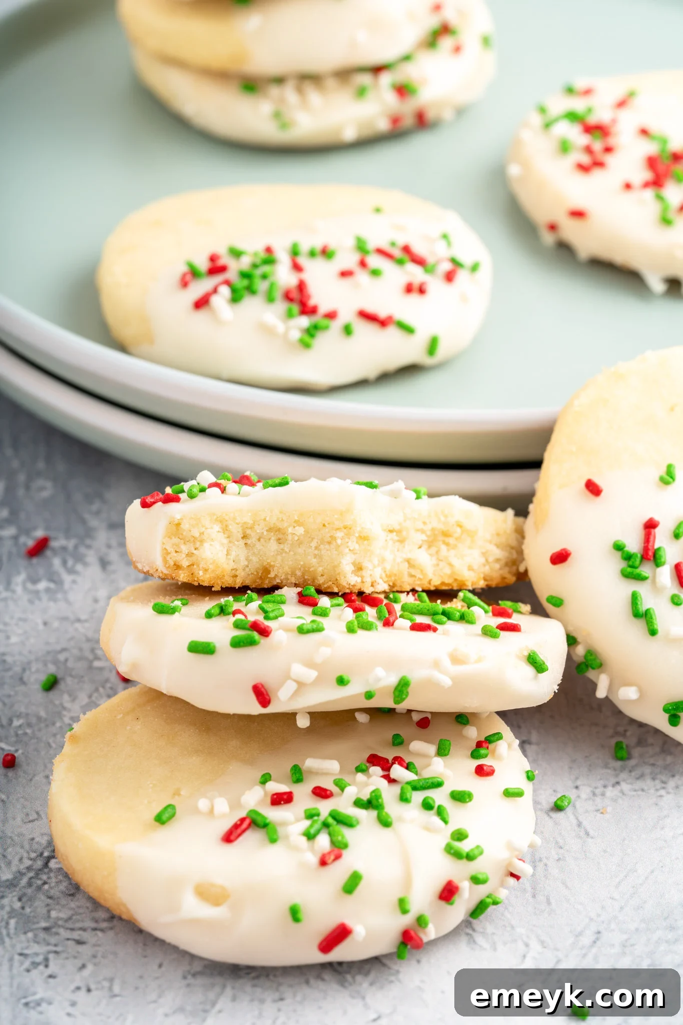 Finished Christmas Shortbread Cookies with frosting and sprinkles, ready to eat.
