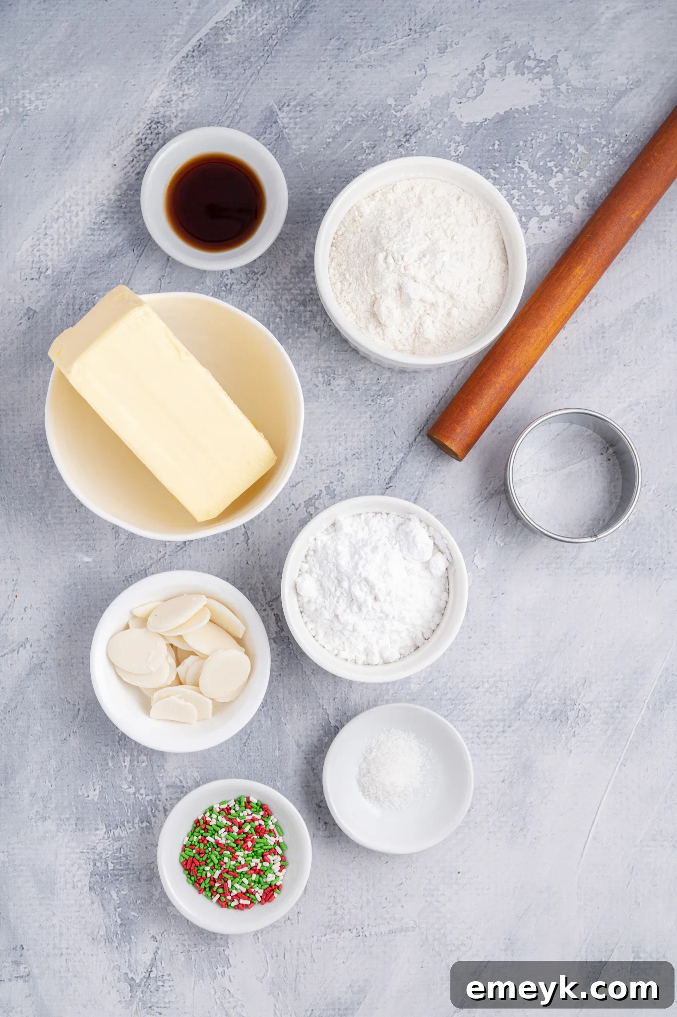 Ingredients for Christmas Shortbread Cookies laid out on a wooden surface.