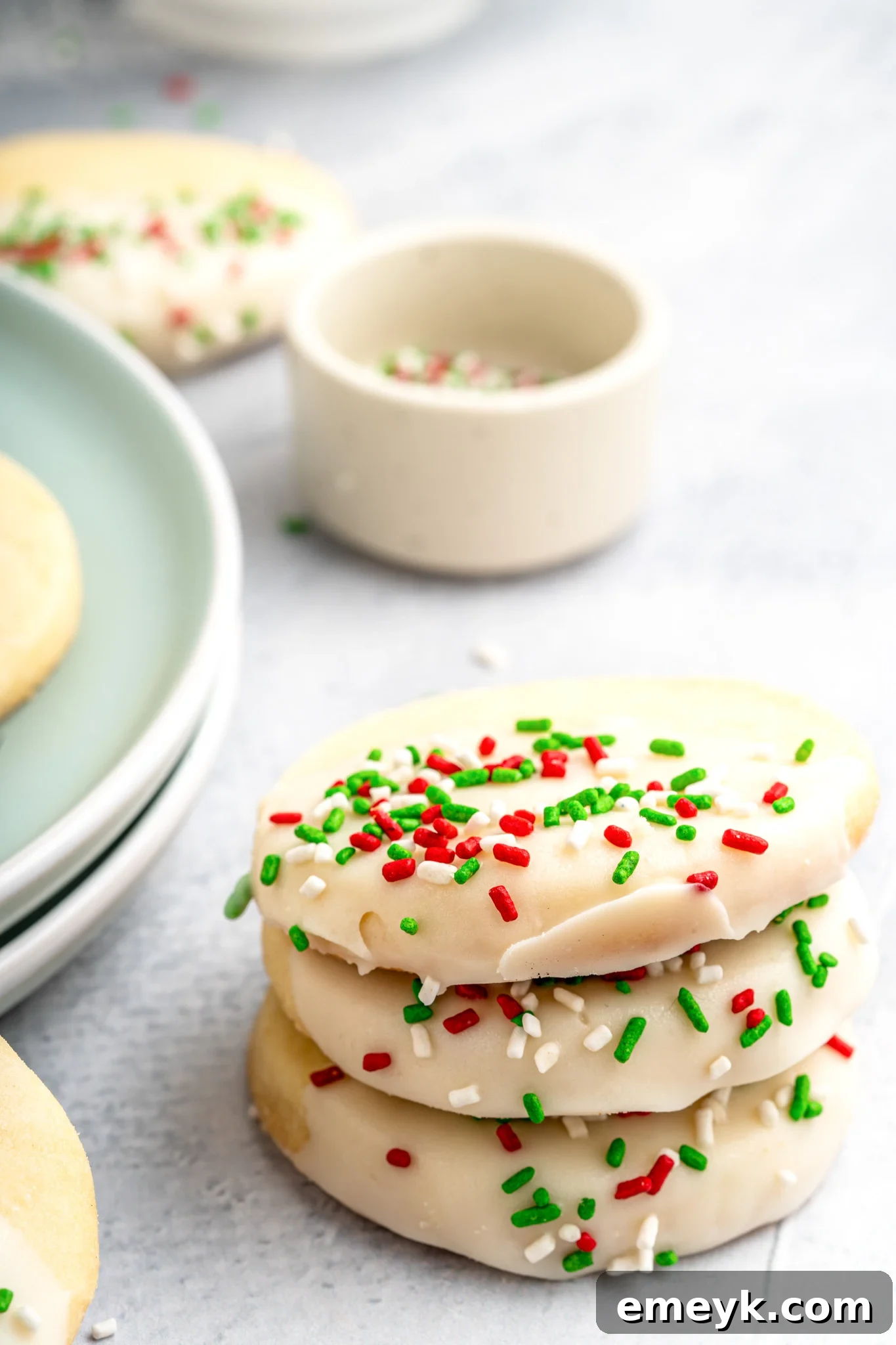 Stack of Christmas Shortbread Cookies, each perfectly decorated with white chocolate and colorful sprinkles.