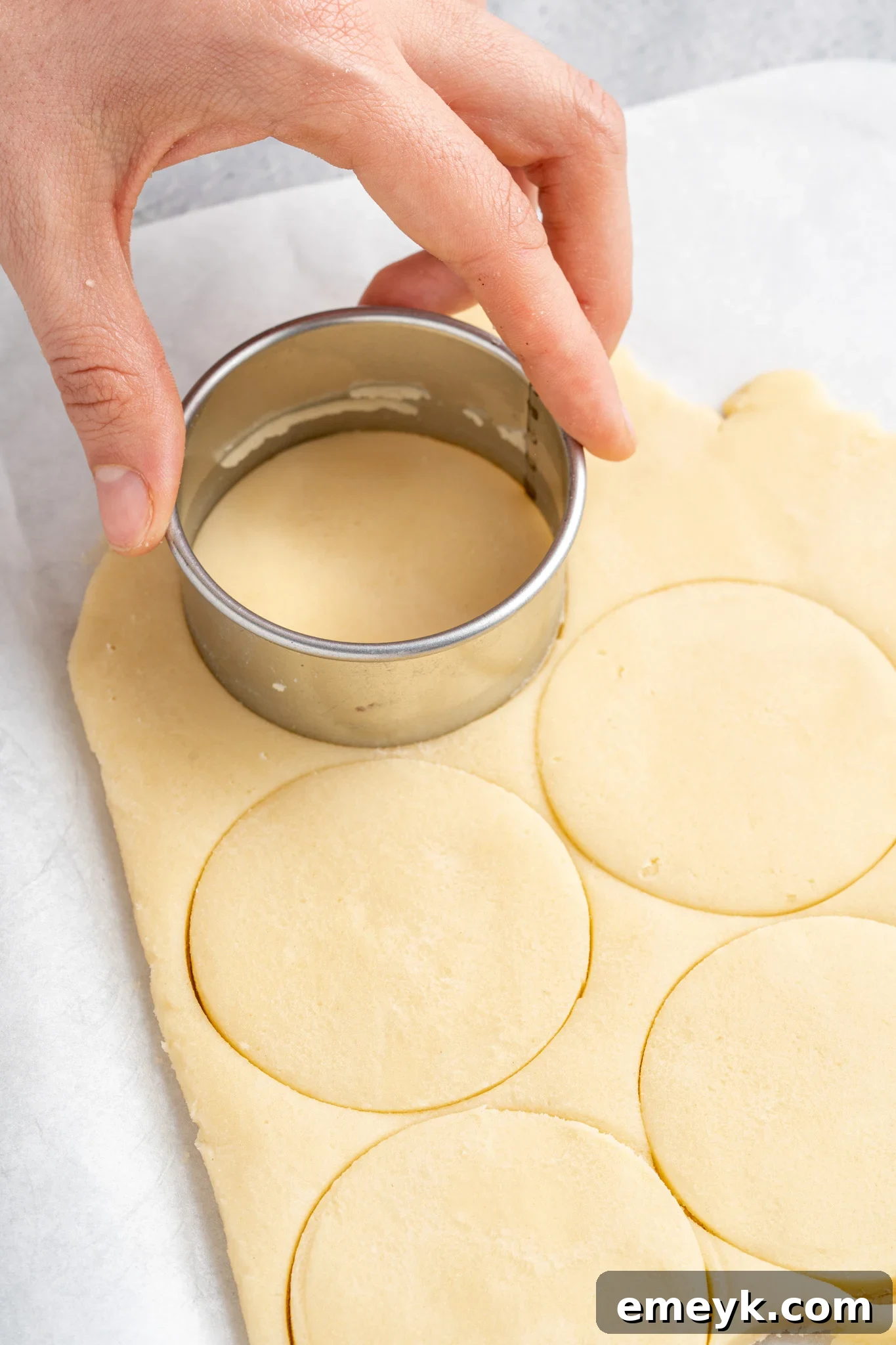 Christmas Shortbread Cookies being cut with cookie cutters.