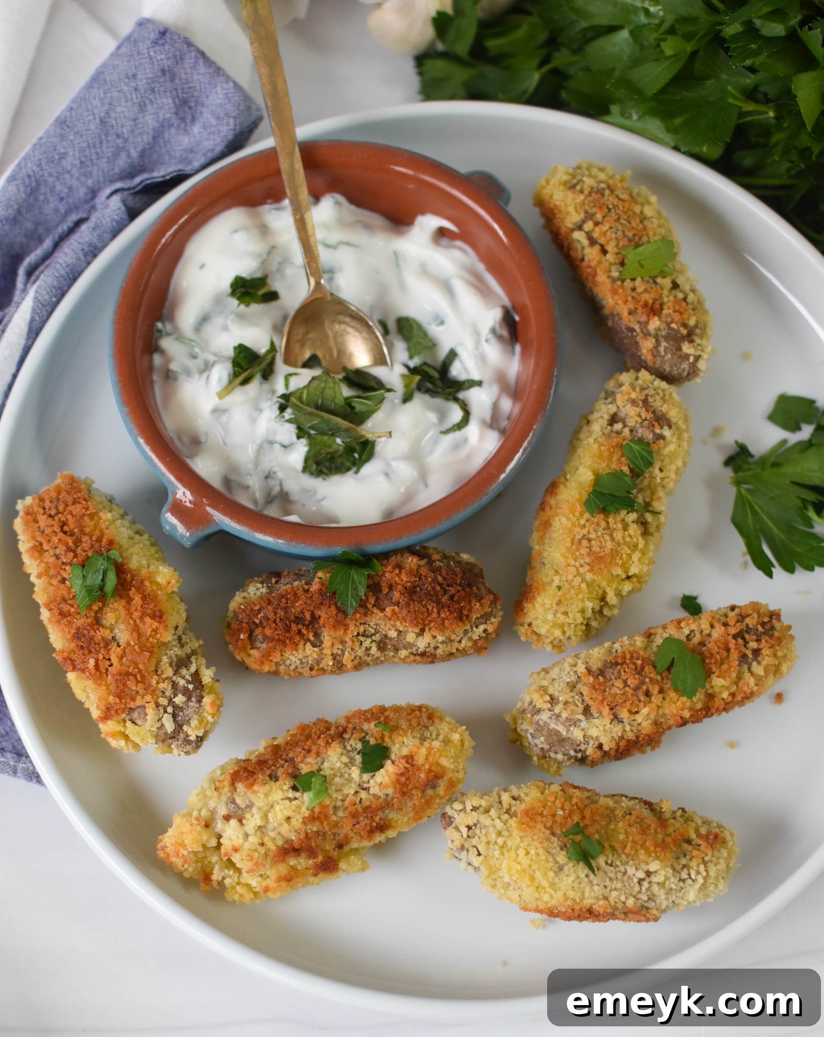 Gourmet Lamb Croquettes 4 Three perfectly cooked lamb croquettes arranged artfully on a white plate, ready to be served.