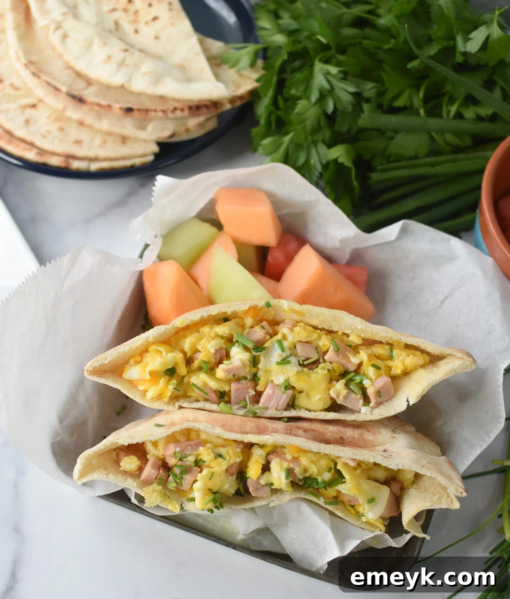 Sunrise Pita Pockets 2 A vibrant Breakfast Pita Recipe served with fresh fruit, showcasing a delicious and healthy morning meal.