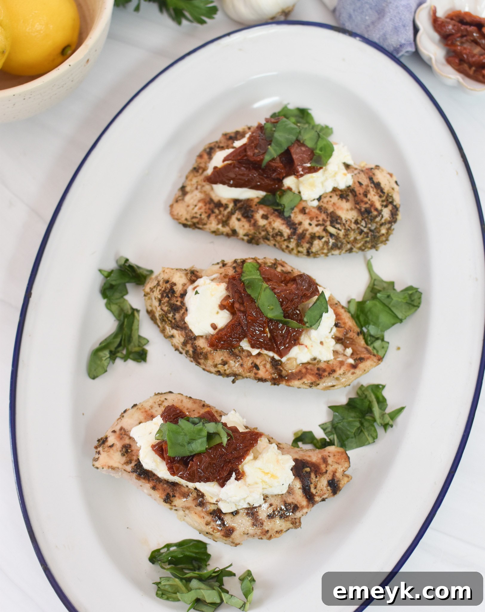 Chicken Bryan on a white and blue patterned platter, ready to be served.