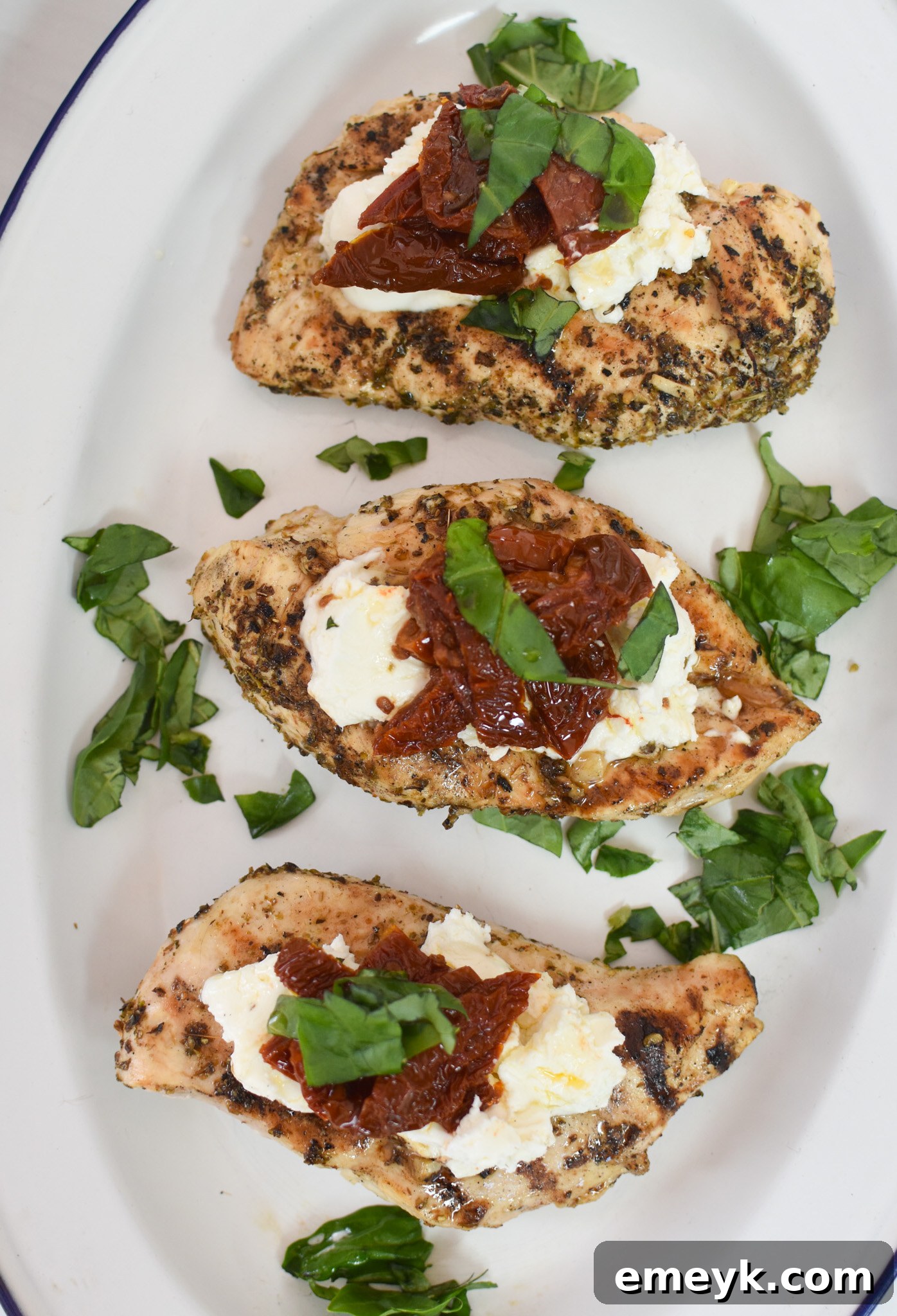 Close-up of Chicken Bryan with basil and goat cheese, highlighting the vibrant colors and fresh ingredients.