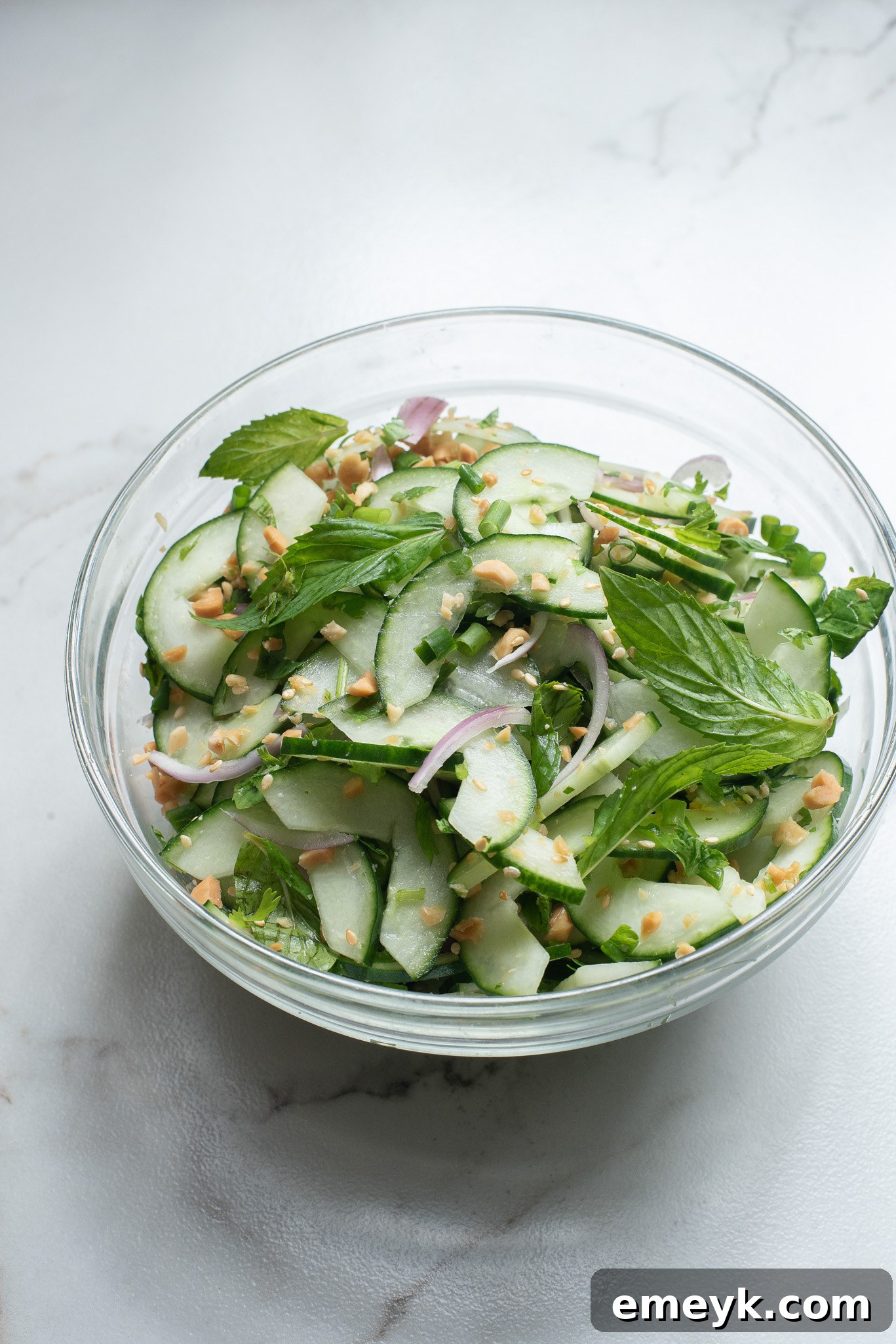 Thai Cucumber Salad ingredients in a glass bowl.