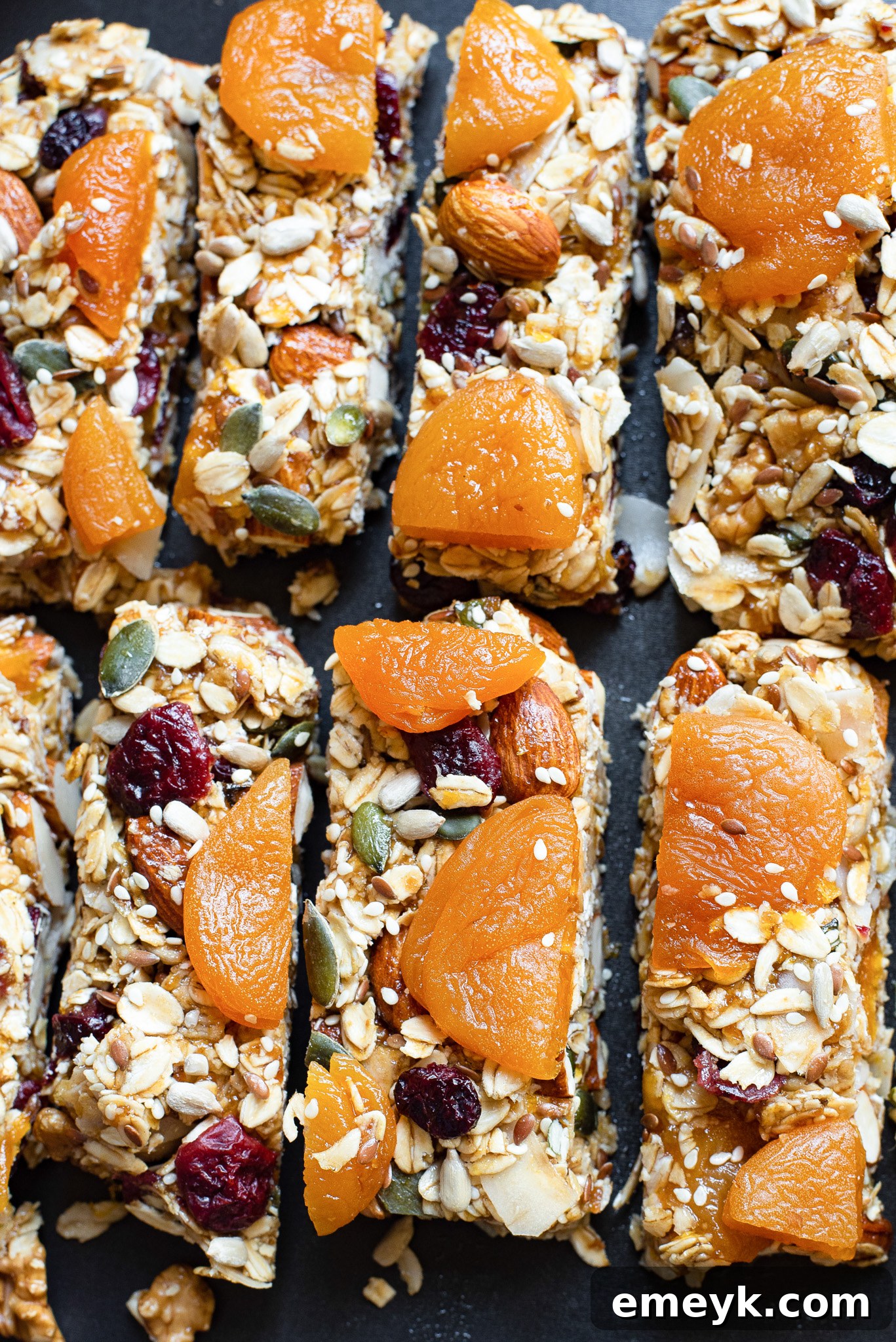 Easy Date Granola Bars artfully arranged on a rustic black board, showcasing their wholesome ingredients and appealing texture.