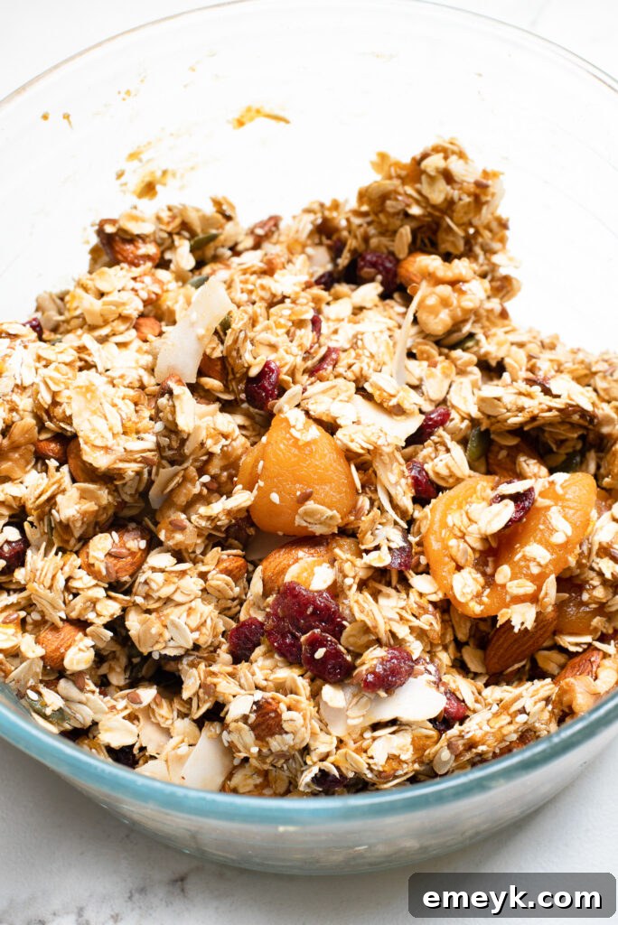 The granola bar mixture, perfectly combined and moist, ready to be pressed into the baking pan for setting.