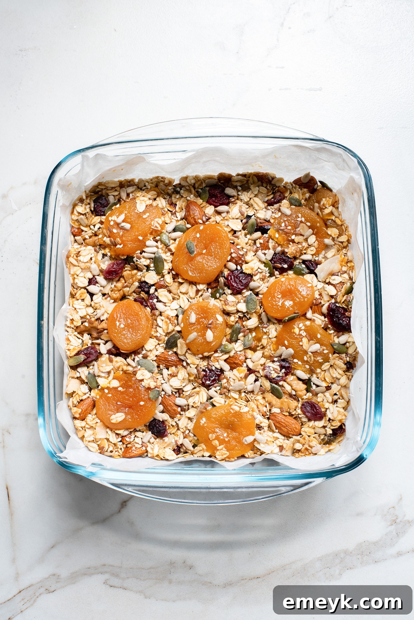 The fully set and chilled date granola bar mixture in the baking dish, perfectly compacted and ready to be sliced.