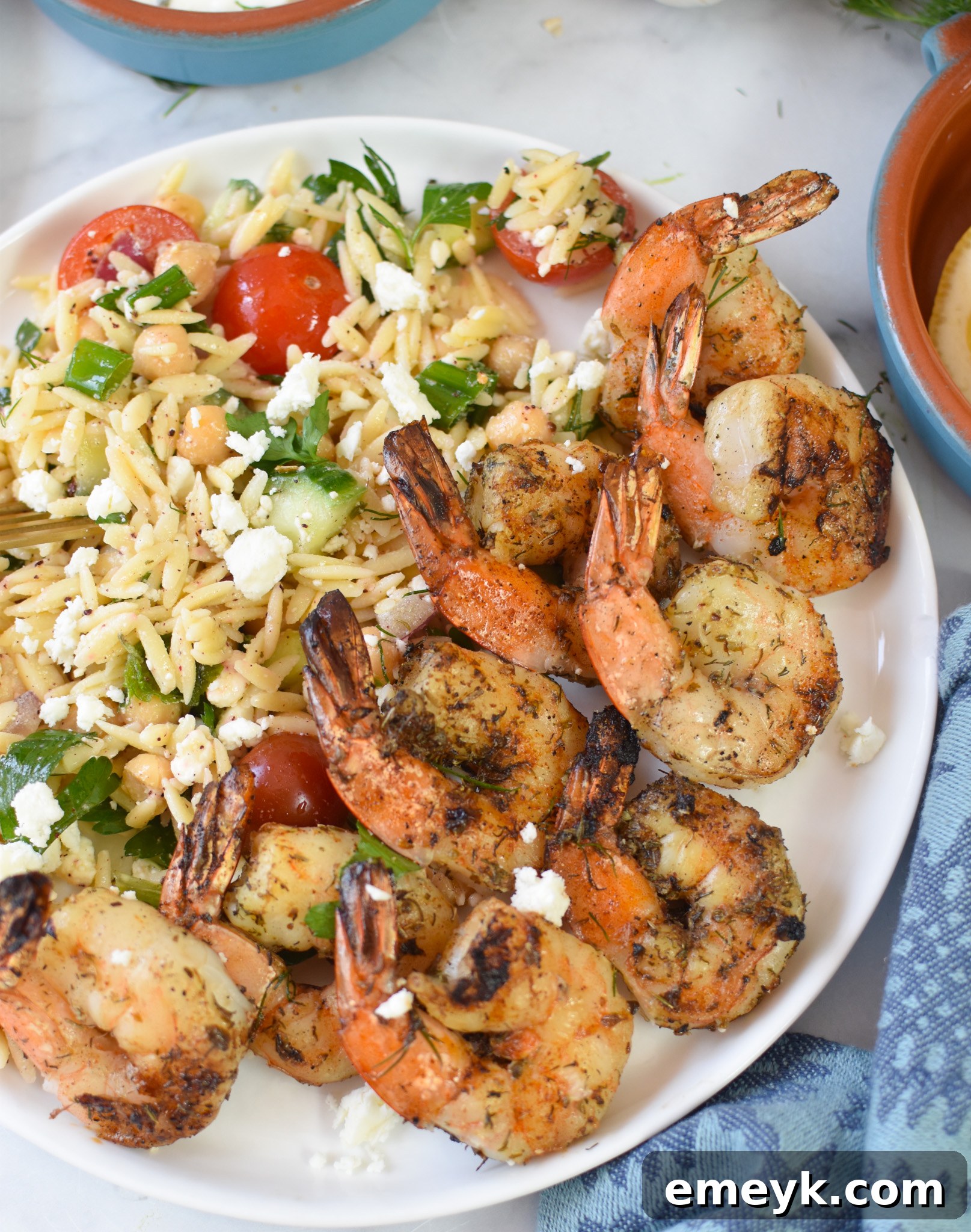 Greek Shrimp Marinade on a plate with orzo salad.