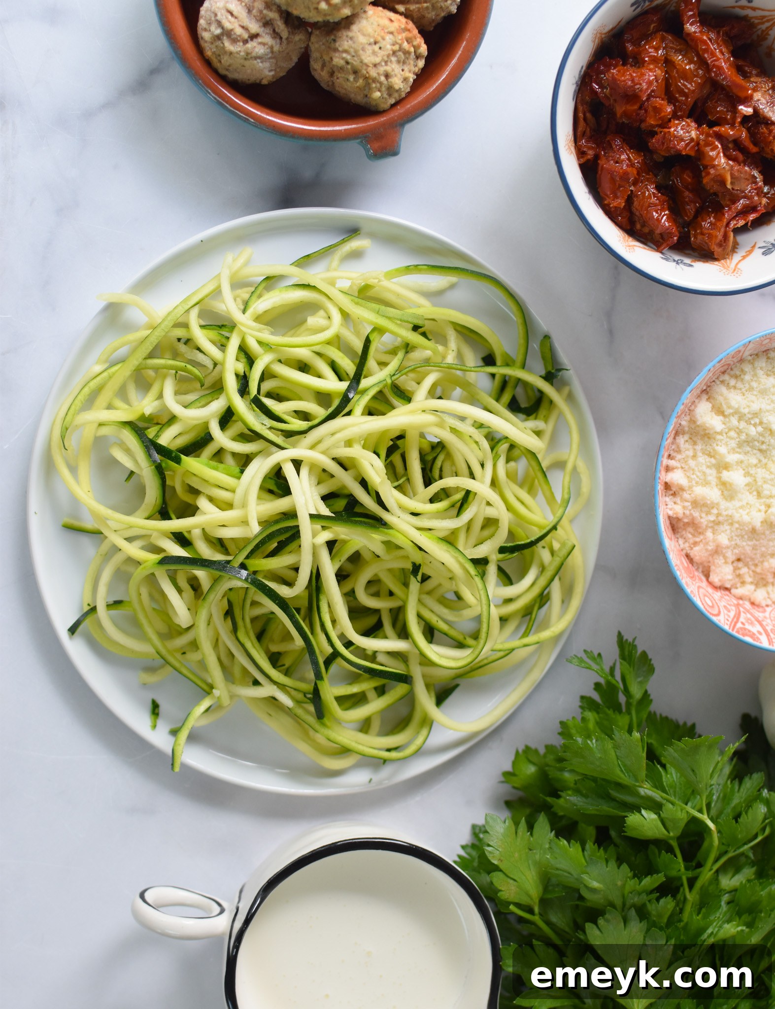 Creamy Zucchini Noodle Alfredo 3 Fresh ingredients for Alfredo Zoodles Recipe including zucchini, cream, cheese, and sun-dried tomatoes.