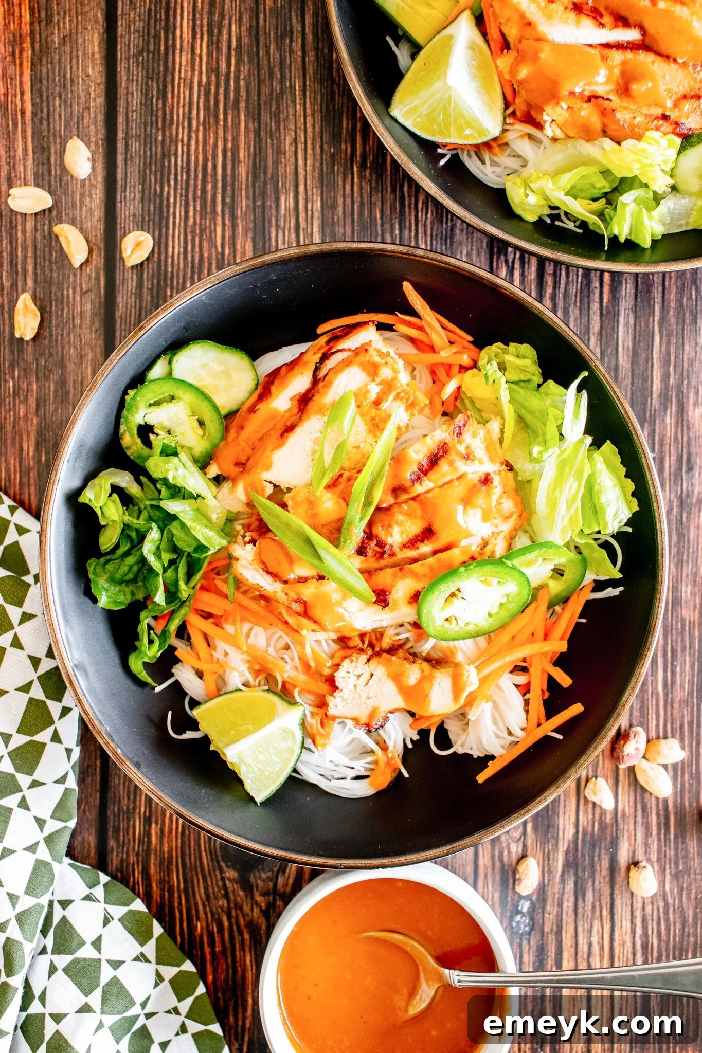 Vibrant Thai Chicken Noodle Salad with shredded carrots and fresh herbs, ready to be served.