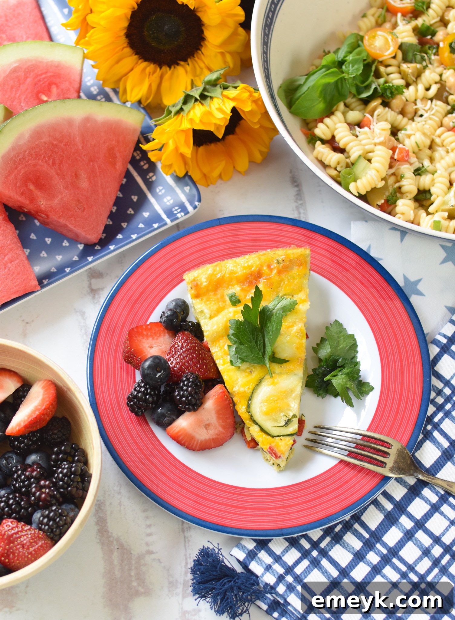 Zucchini Frittata Recipe served on a blue and red plate, garnished with fresh herbs.