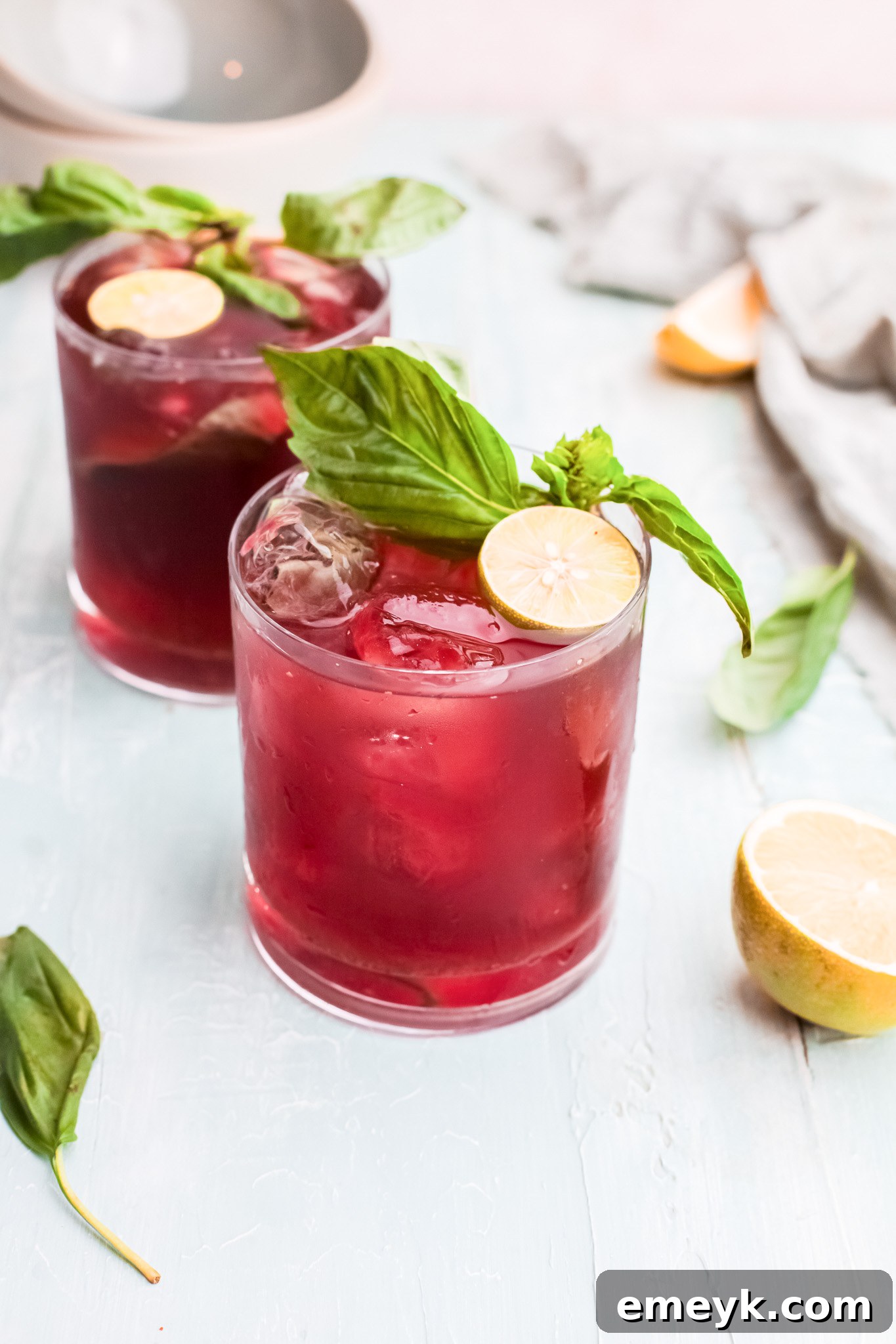 Two glasses of finished Vodka Cherry Limeade ready to be served.