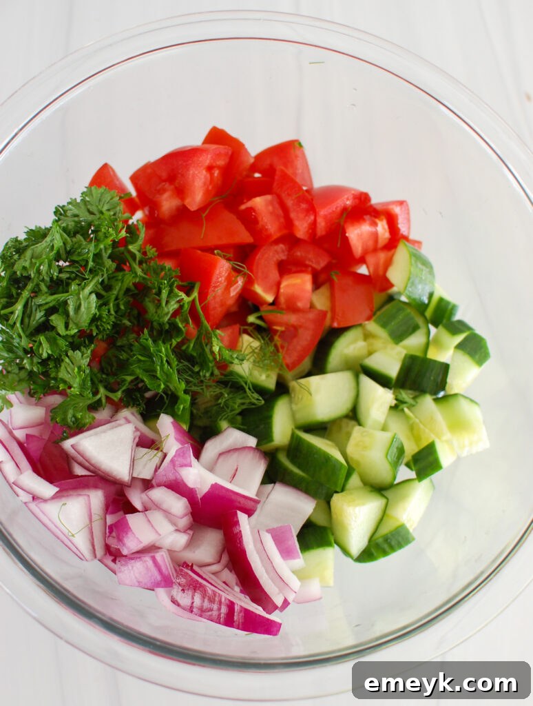 Freshly chopped ingredients for Tomato Cucumber Salad with Yogurt Dressing before mixing.