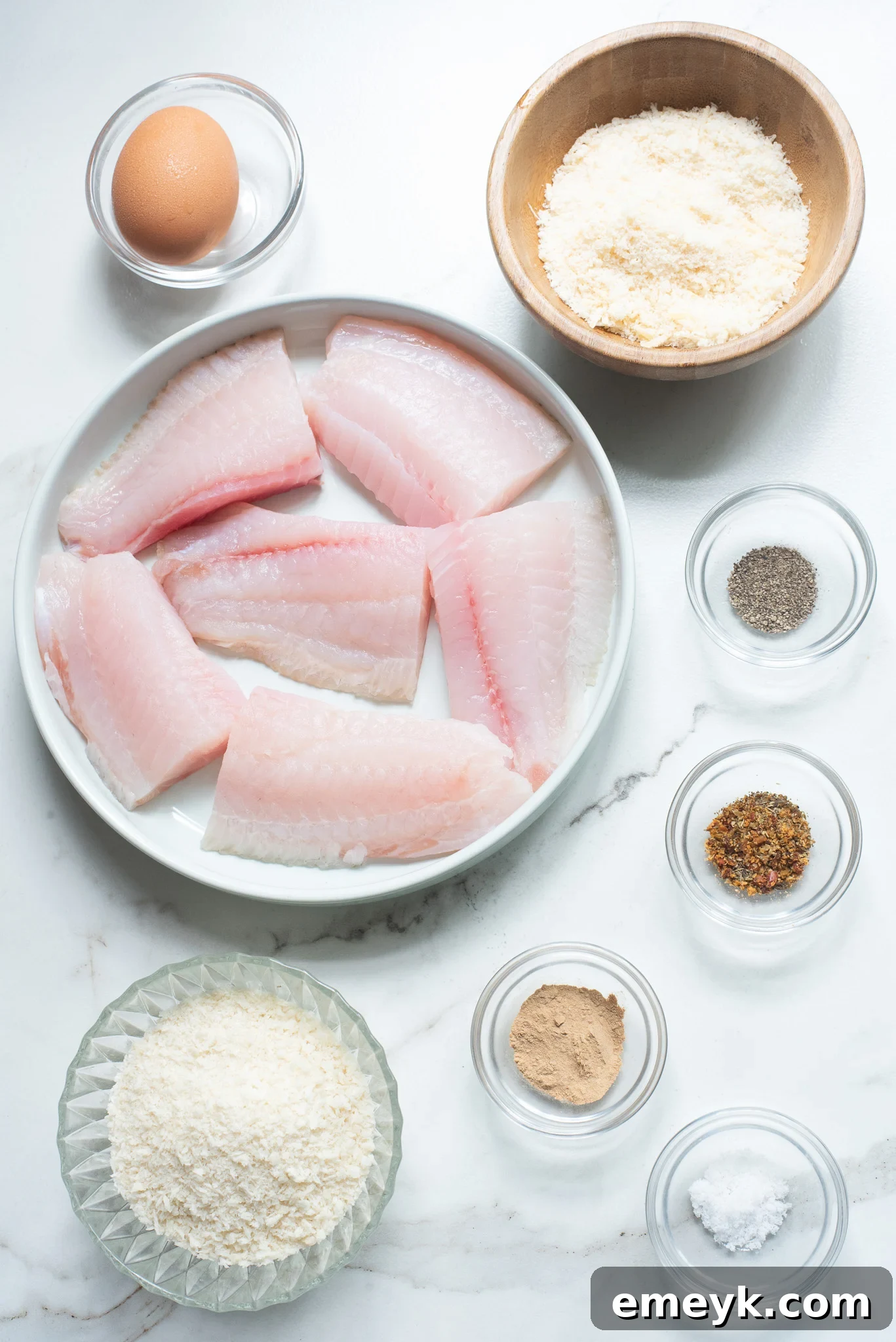 Ingredients for Easy Pan Fried Fish laid out on a wooden board.