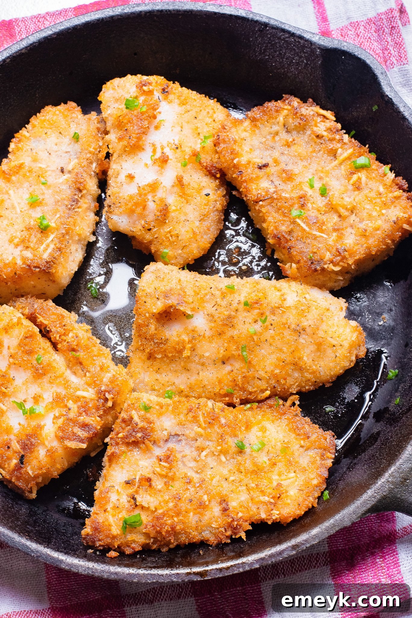 Easy Pan Fried Fish cooking in a hot skillet, showing a crispy crust forming.